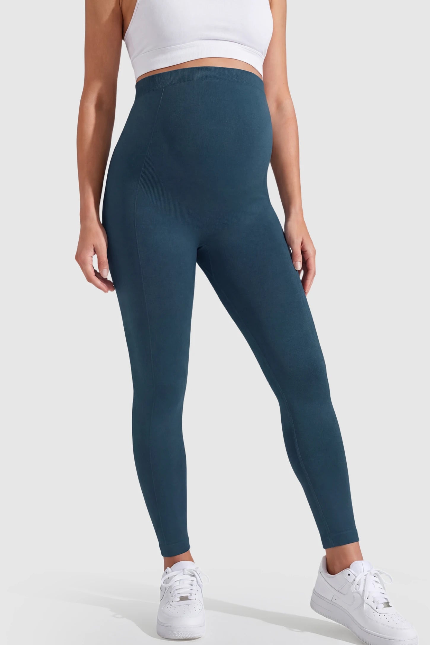 Over-The-Belly Full-Length Maternity Yoga Leggings Over-The-Belly Full-Length Maternity Yoga Leggings in teal featuring contouring bodycon fit and supportive full panel on pregnant model.