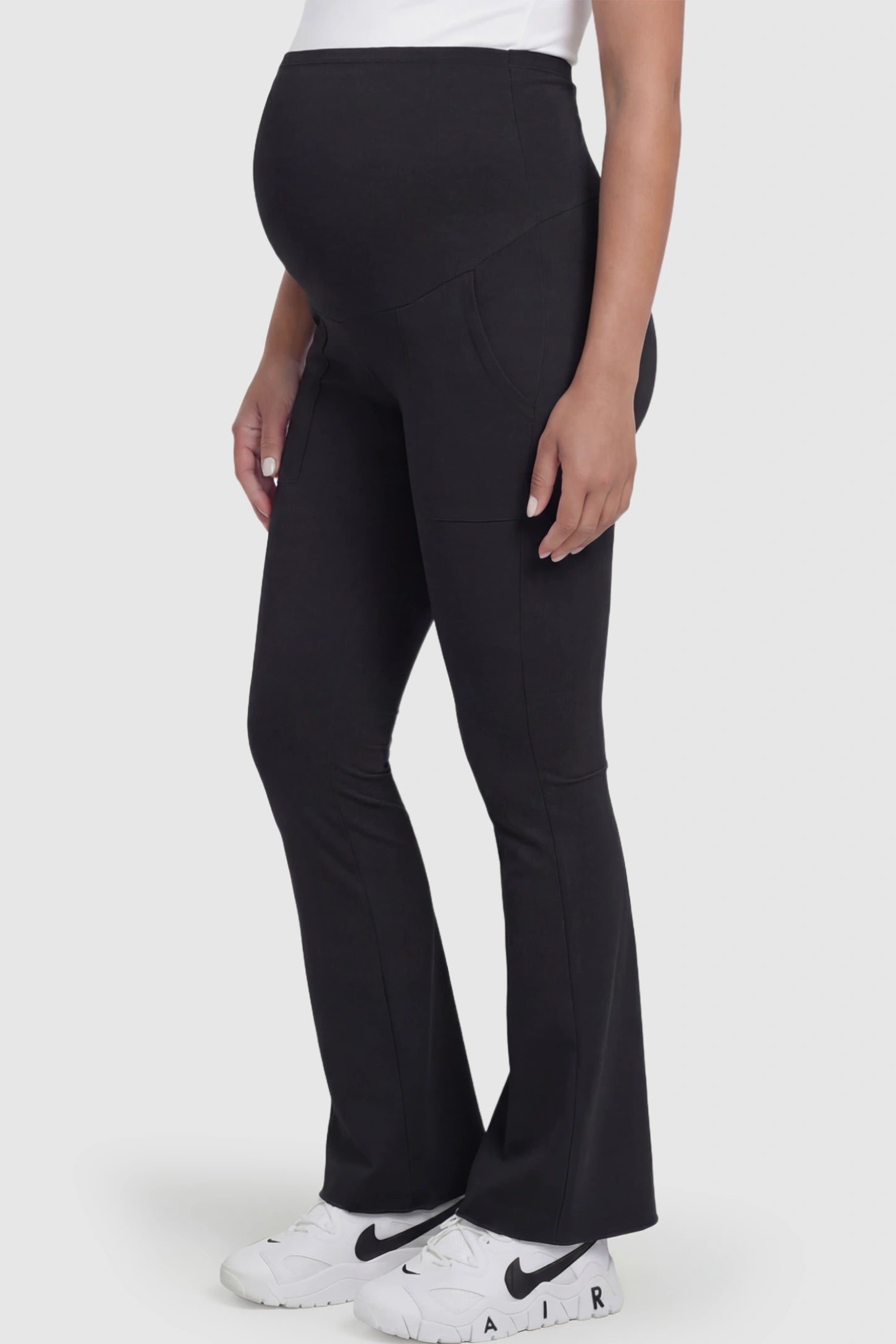 Full Panel Pocketed Flare Leg Maternity Leggings Full Panel Pocketed Flare Leg Maternity Leggings in Black featuring a ribbed over-the-bump panel on a pregnant model.