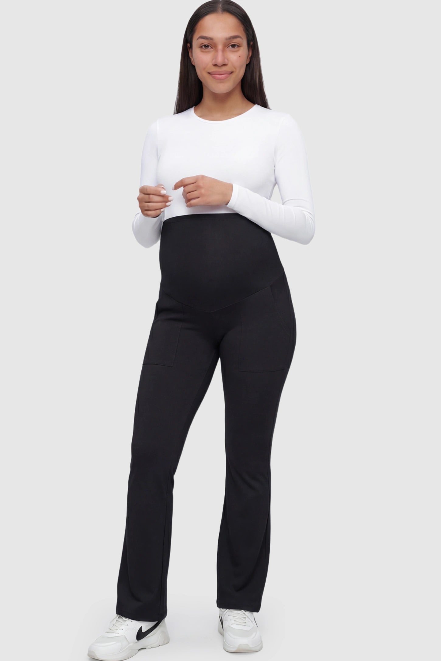 Full Panel Pocketed Flare Leg Maternity Leggings in Black featuring a ribbed over-the-bump panel on a pregnant model.
