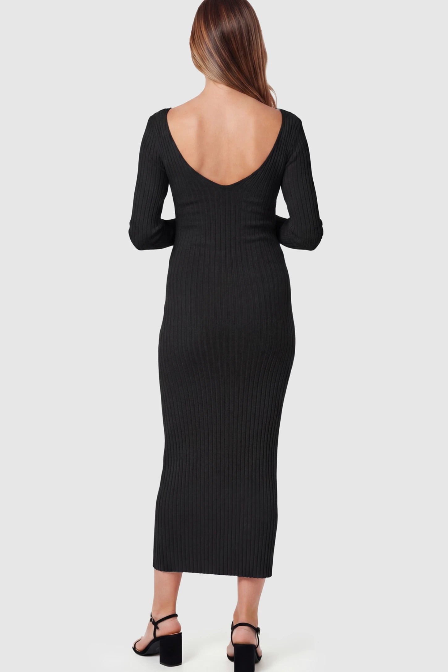 Ribbed V-Neck Long Sleeve Maternity Midi Dress Ribbed V-Neck Maternity Midi Dress in Black featuring a fitted long sleeve on a pregnant model.