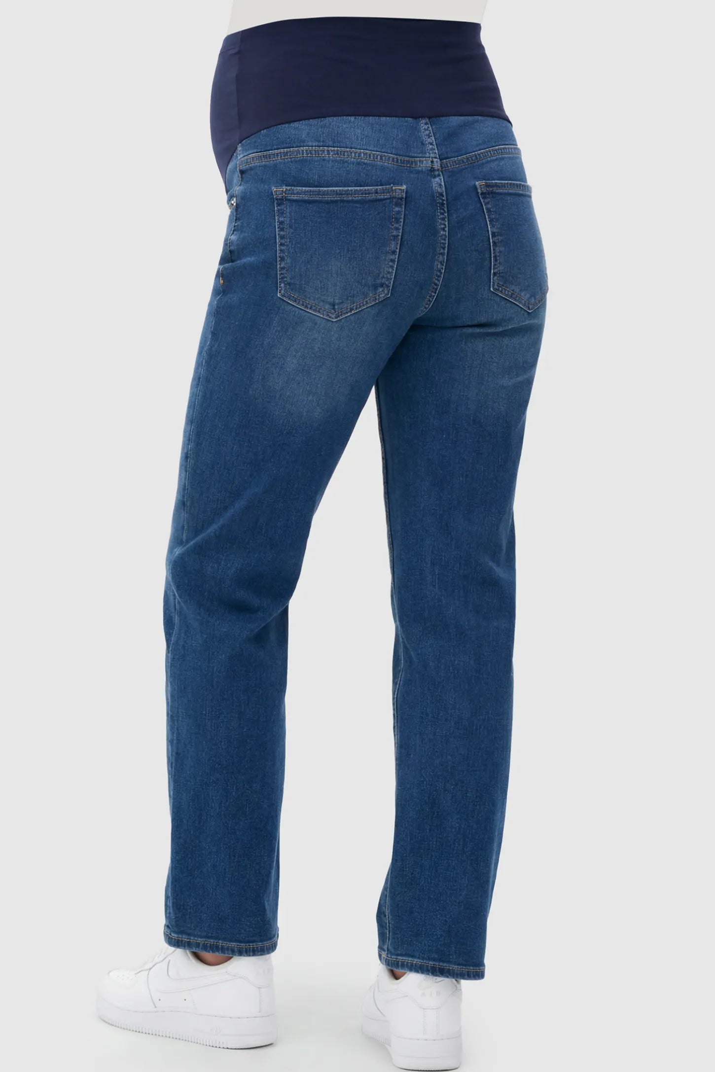 Full Panel Stretch Straight Leg Maternity Jeans Full Panel Stretch Straight Leg Maternity Jeans in Blue featuring a seamless navy waistband on a pregnant model showing back.