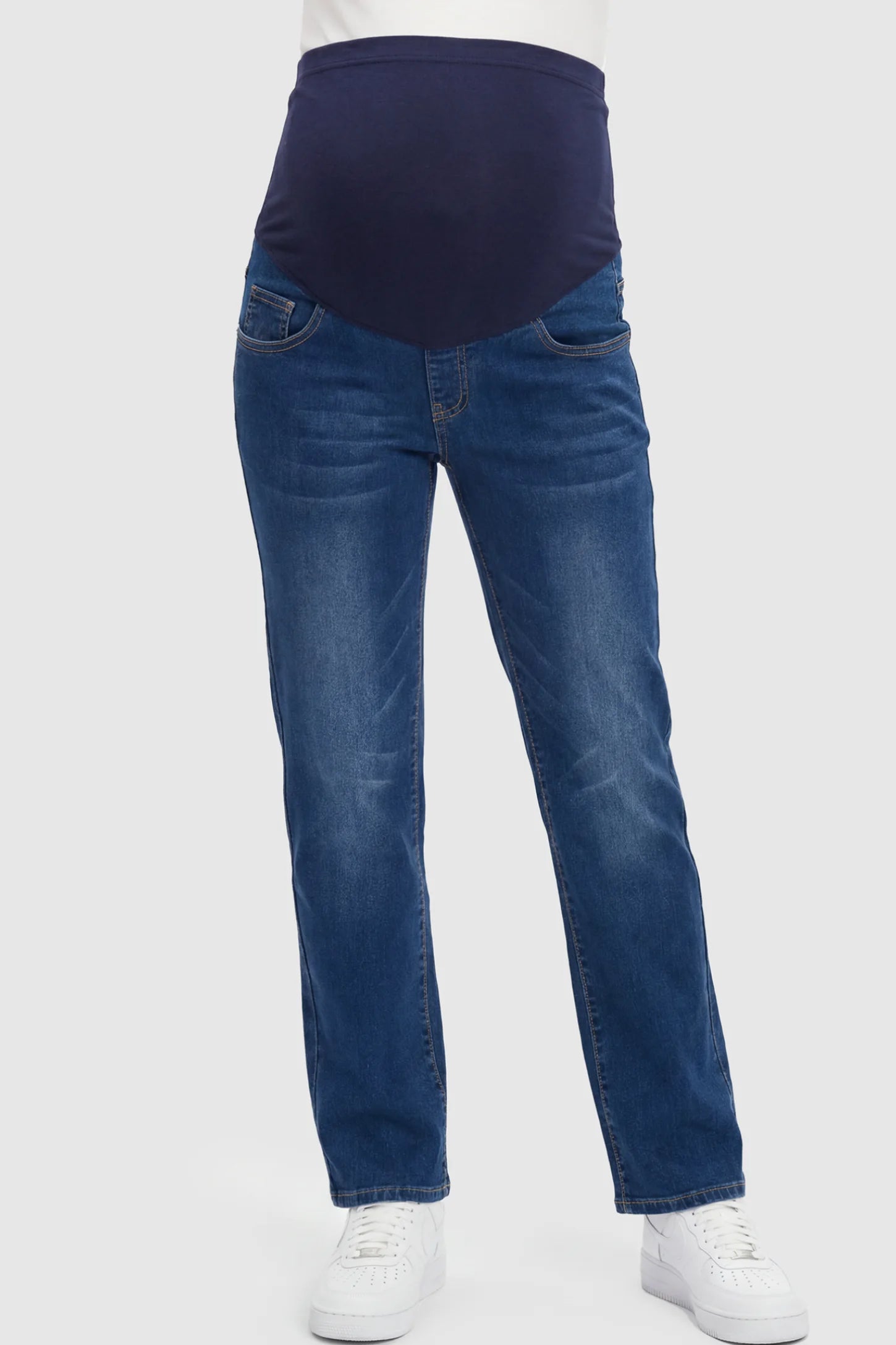 Full Panel Stretch Straight Leg Maternity Jeans in Blue featuring a seamless navy waistband on a pregnant model showing front.