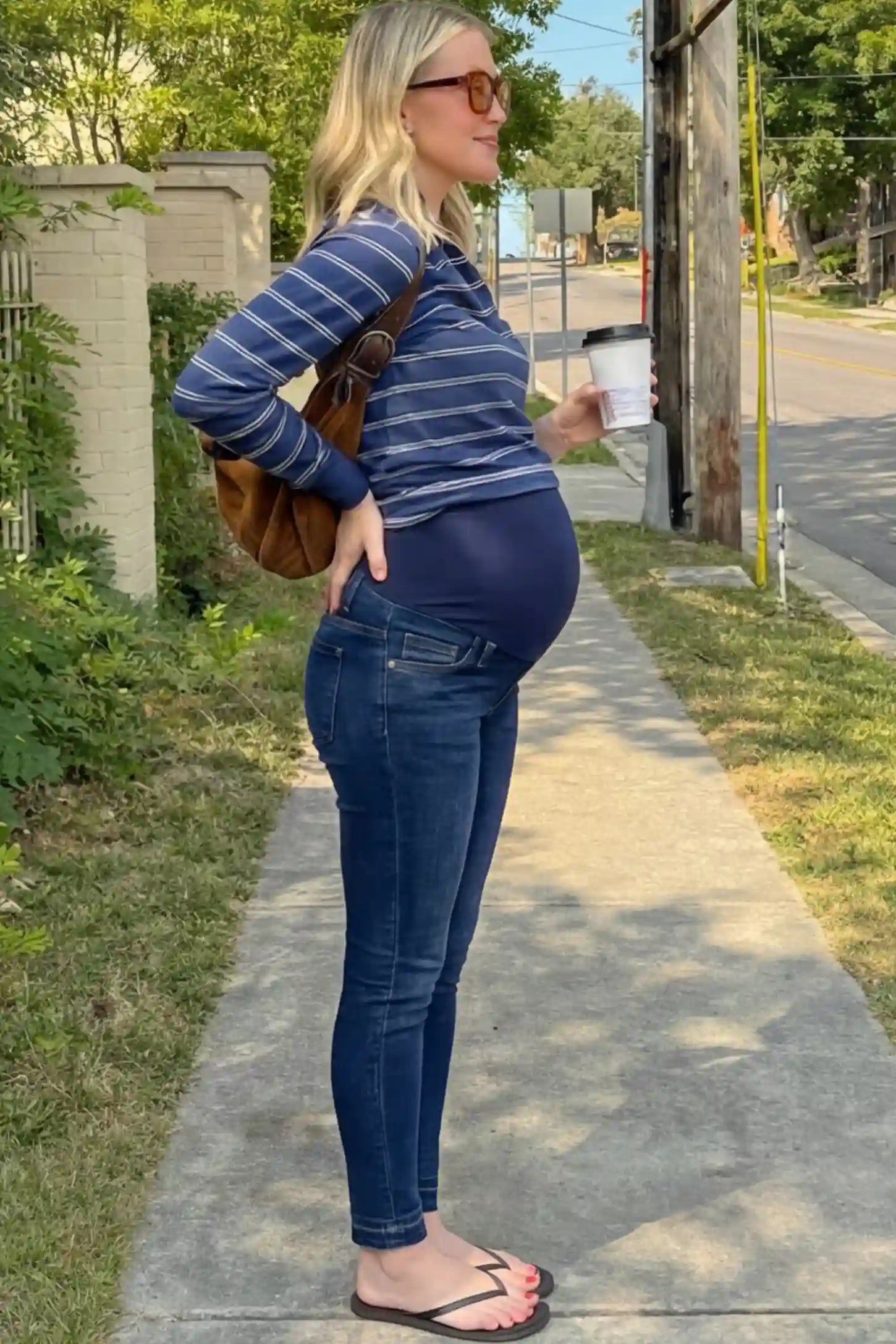 Full Panel Released Hem Maternity Skinny Jeans Full Panel Released Hem Maternity Skinny Jeans in dark blue featuring a released hem and over-the-belly panel on a pregnant woman.