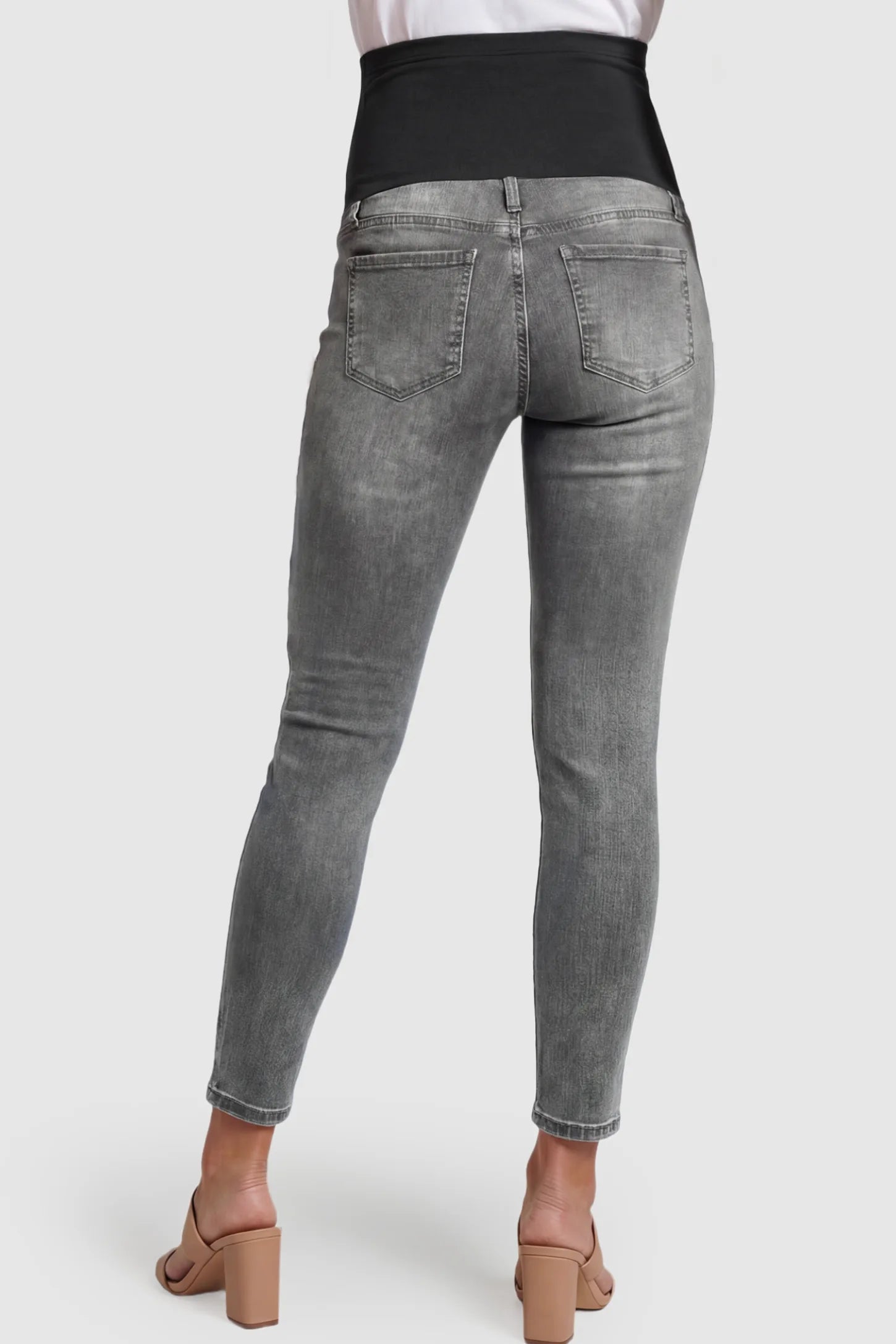 Full Panel Released Hem Maternity Skinny Jeans Full Panel Released Hem Maternity Skinny Jeans in Gray featuring a released hem and over-the-belly panel on a pregnant model showing back.