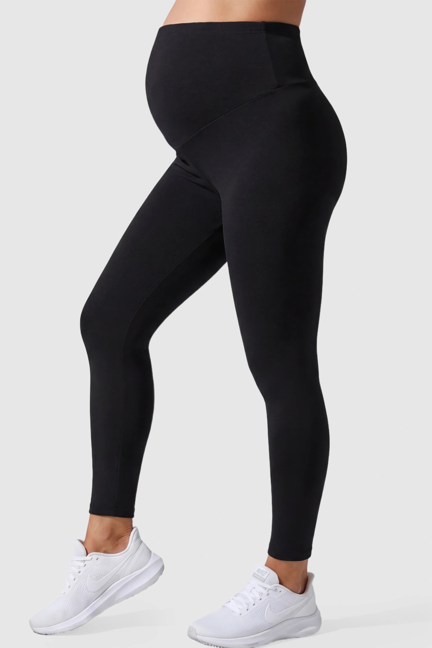 Full Panel Slim Fit Maternity Leggings Full Panel Slim Fit Maternity Leggings in Black featuring a seamless over-the-belly waistband on a pregnant model showing side.