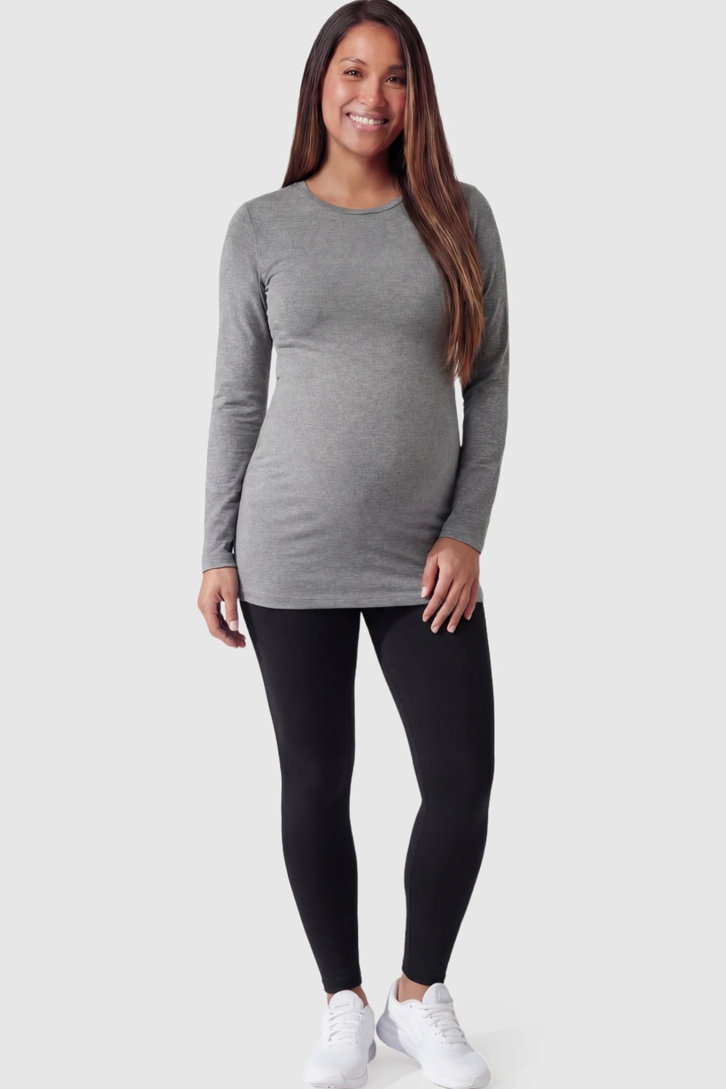Full Panel Slim Fit Maternity Leggings Full Panel Slim Fit Maternity Leggings in Black featuring a seamless over-the-belly waistband on a pregnant model facing front.