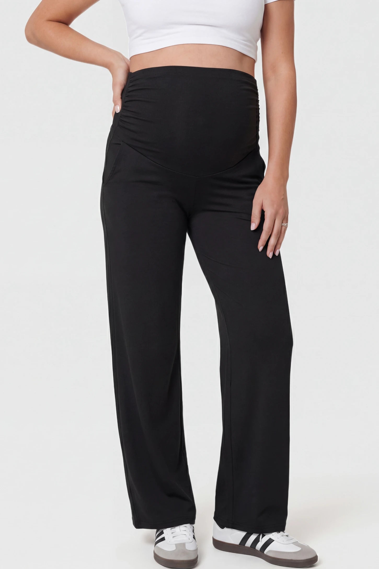 Ruched Full Panel Wide-Leg Maternity Pants in Black featuring side pockets on a pregnant model.