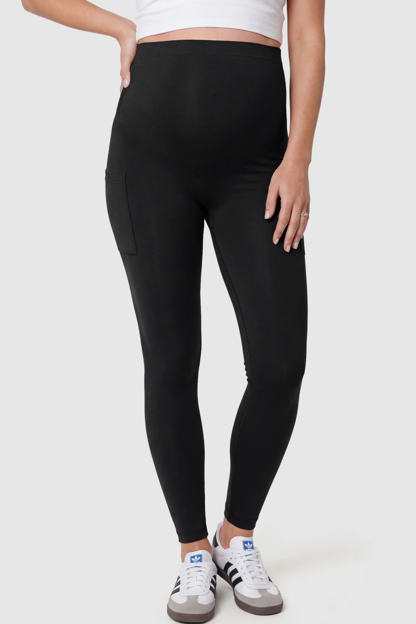 High-Waist Ankle-Length Pocketed Maternity Leggings in Black featuring a seamless waistband on a pregnant model.