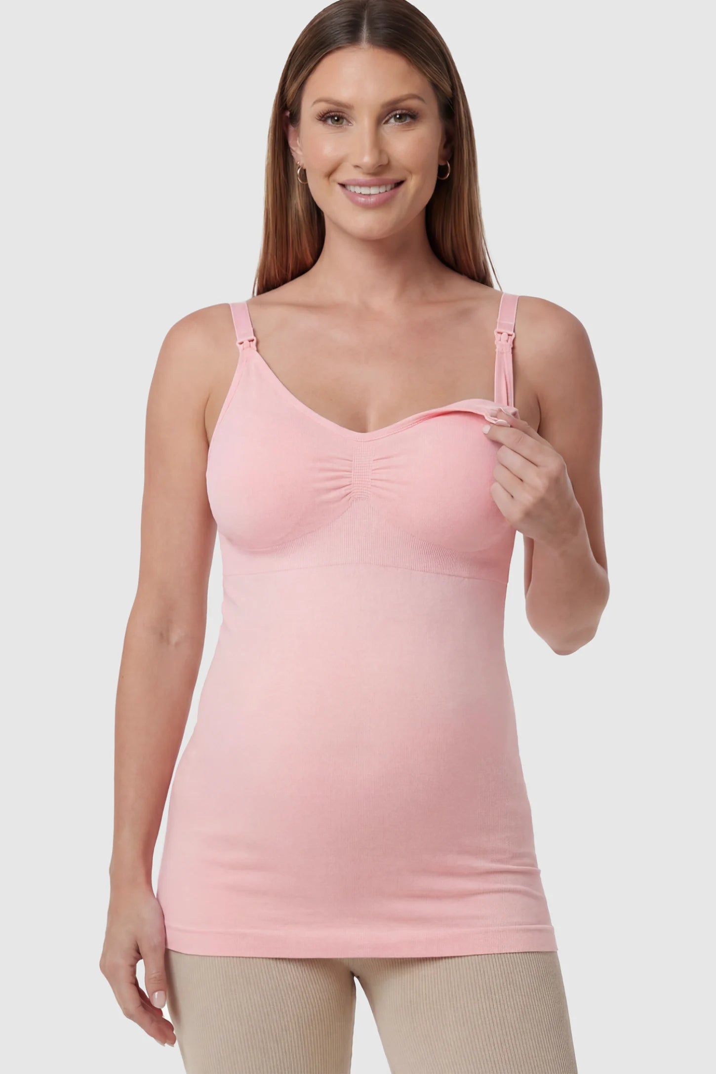 Solid Seamless Maternity & Nursing Camisole Solid Seamless Maternity & Nursing Camisole in Pink featuring one-handed nursing clips on a pregnant model.