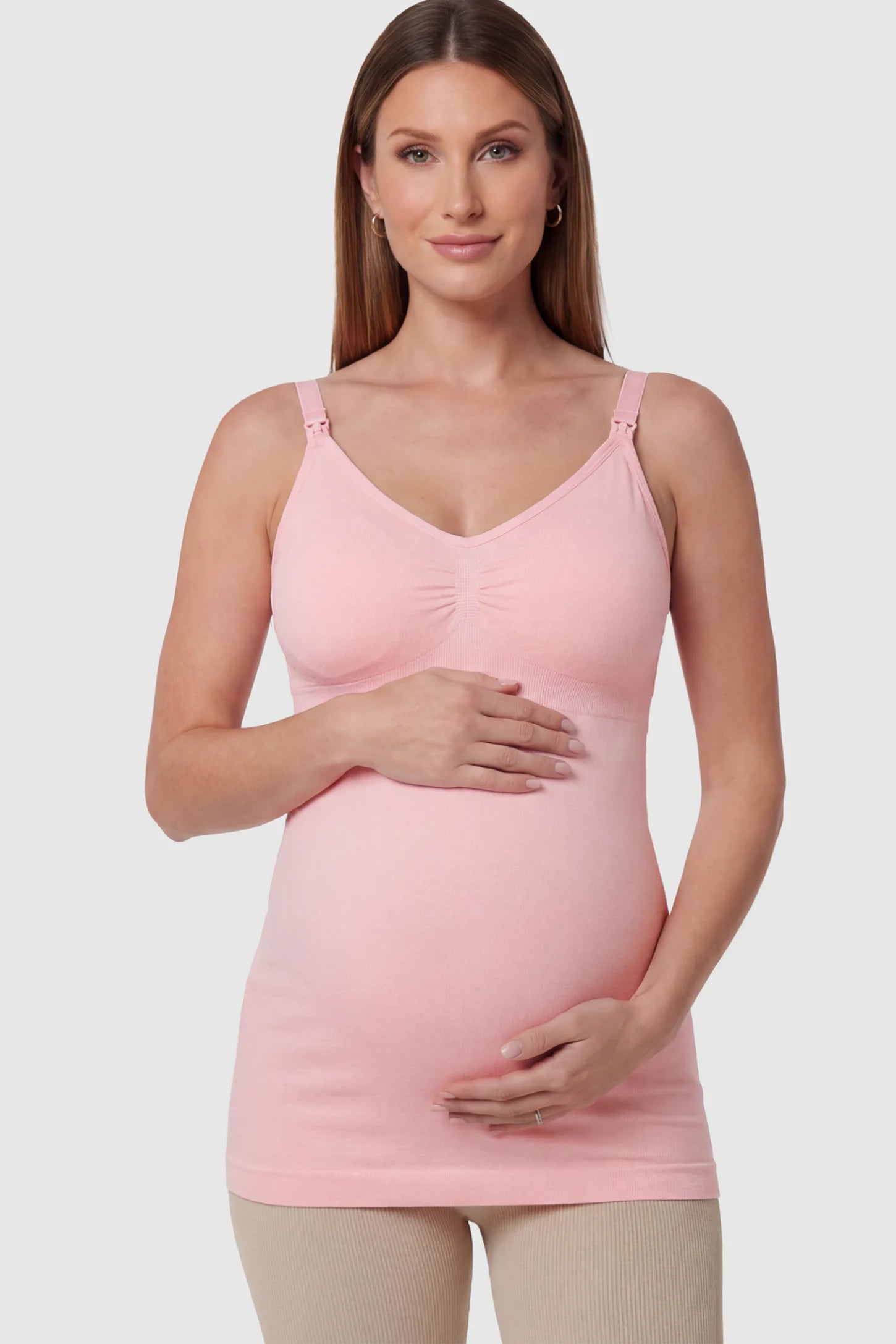 Solid Seamless Maternity & Nursing Camisole Solid Seamless Maternity & Nursing Camisole in Pink featuring one-handed nursing clips on a pregnant model.