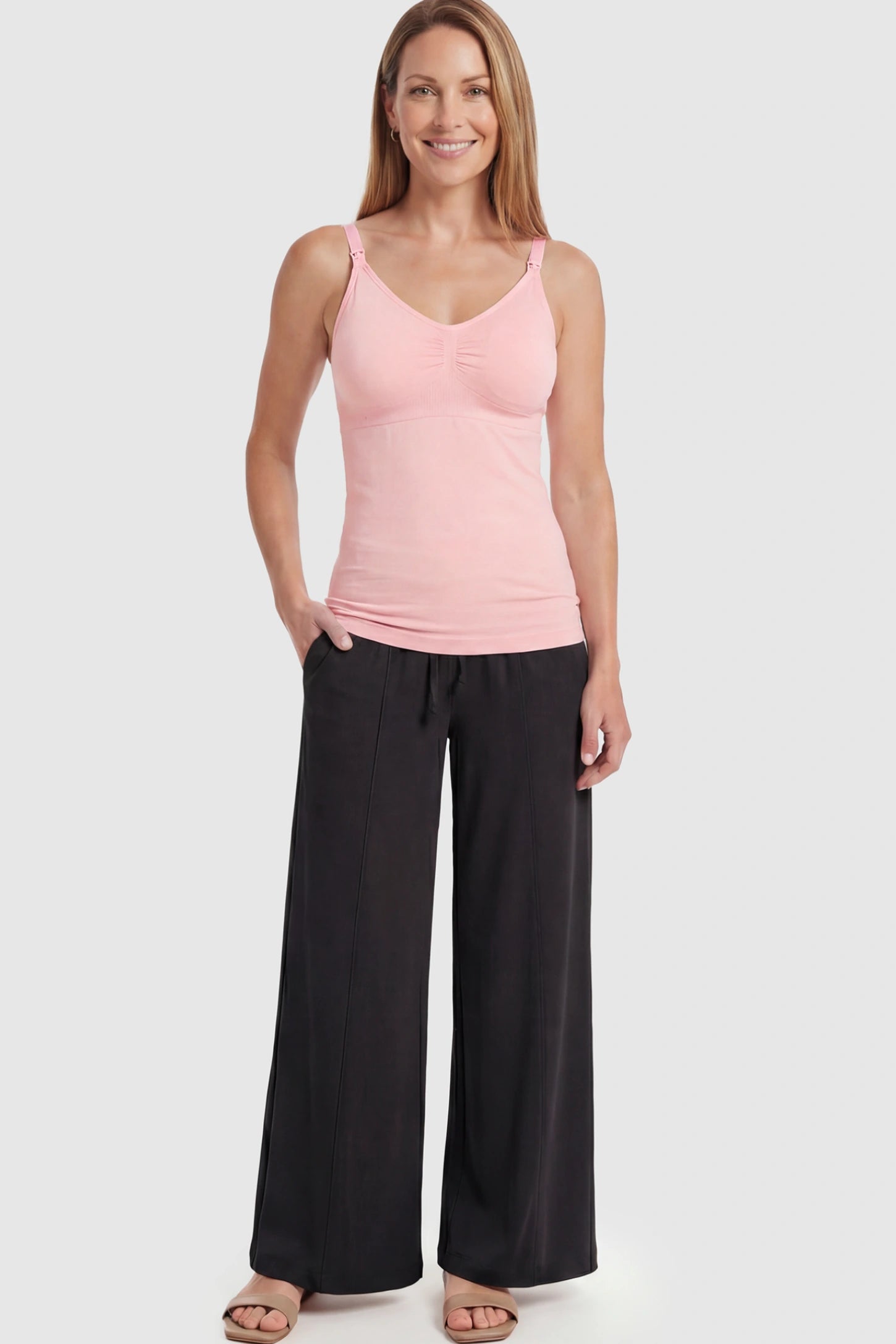 Solid Seamless Maternity & Nursing Camisole Solid Seamless Maternity & Nursing Camisole in Pink featuring one-handed nursing clips on a postpartum model.