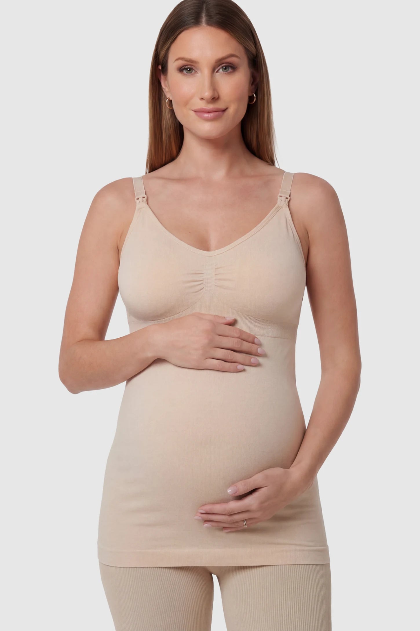 Solid Seamless Maternity & Nursing Camisole Solid Seamless Maternity & Nursing Camisole in Skin featuring one-handed nursing clips on a pregnant model.