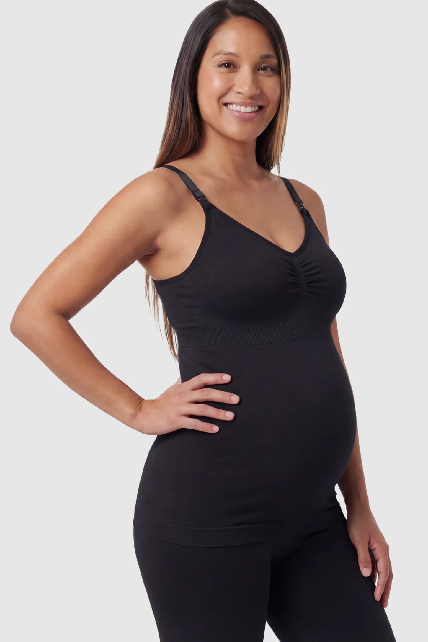 Solid Seamless Maternity & Nursing Camisole Solid Seamless Maternity & Nursing Camisole in Black featuring one-handed nursing clips on a pregnant model.