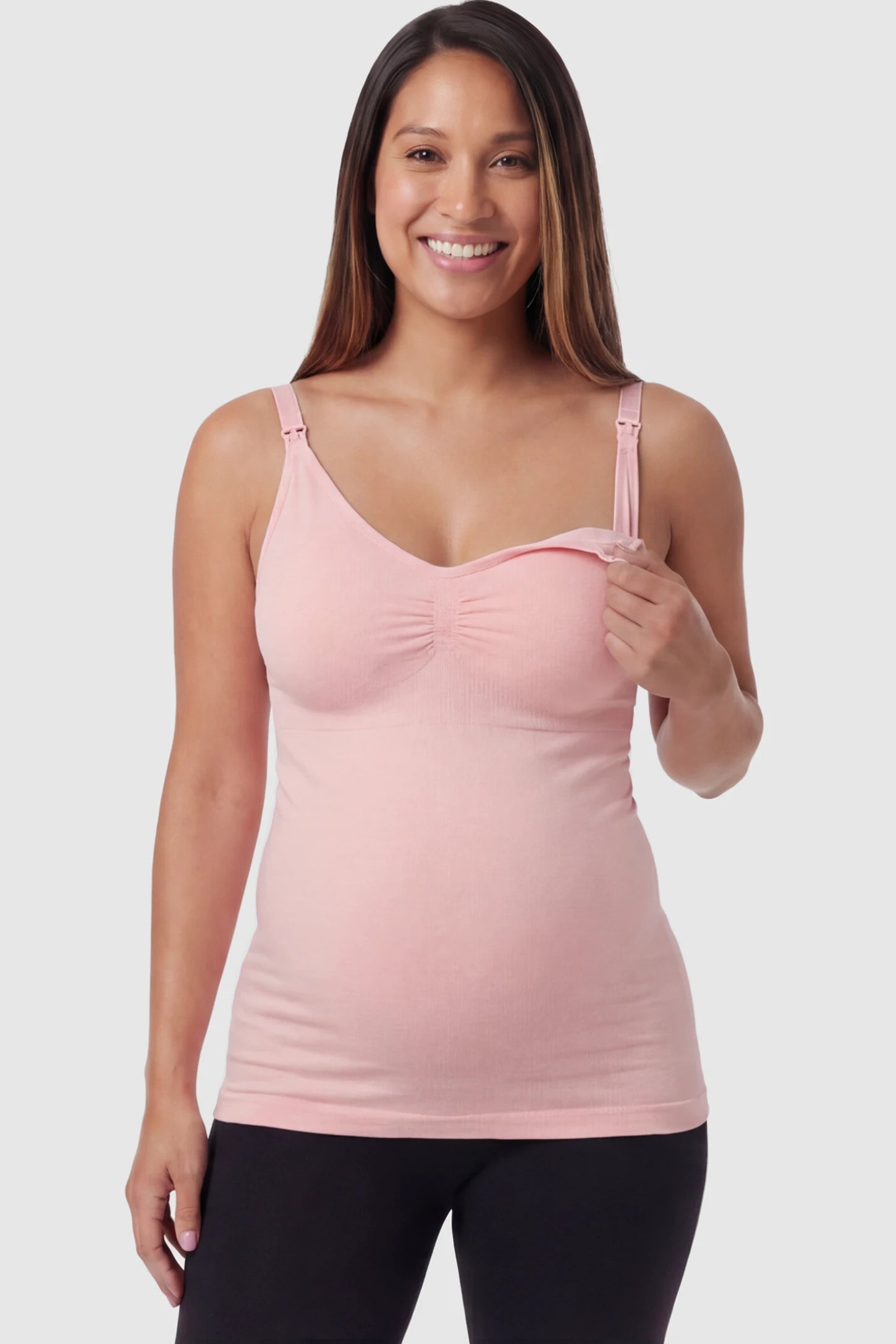 Solid Seamless Maternity & Nursing Camisole Solid Seamless Maternity & Nursing Camisole in Pink featuring one-handed nursing clips on a pregnant model.