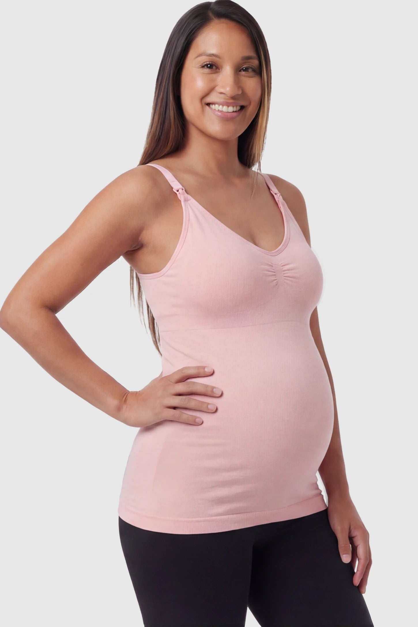 Solid Seamless Maternity & Nursing Camisole Solid Seamless Maternity & Nursing Camisole in Pink featuring one-handed nursing clips on a pregnant model.