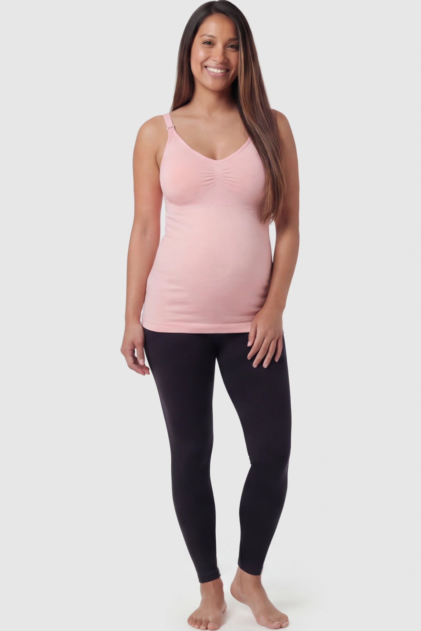 Solid Seamless Maternity & Nursing Camisole Solid Seamless Maternity & Nursing Camisole in Pink featuring one-handed nursing clips on a pregnant model.