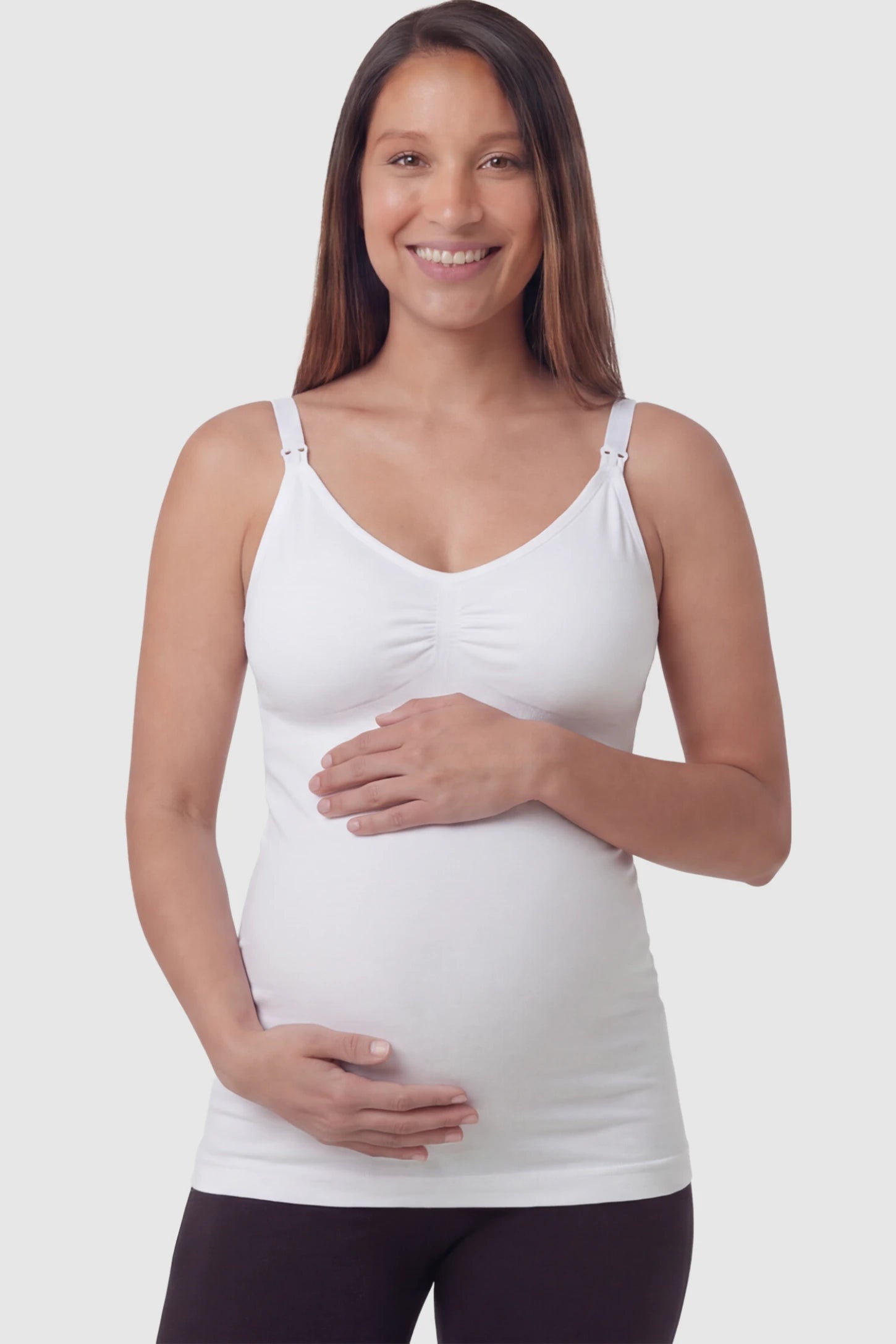 Solid Seamless Maternity & Nursing Camisole Solid Seamless Maternity & Nursing Camisole in White featuring one-handed nursing clips on a pregnant model.