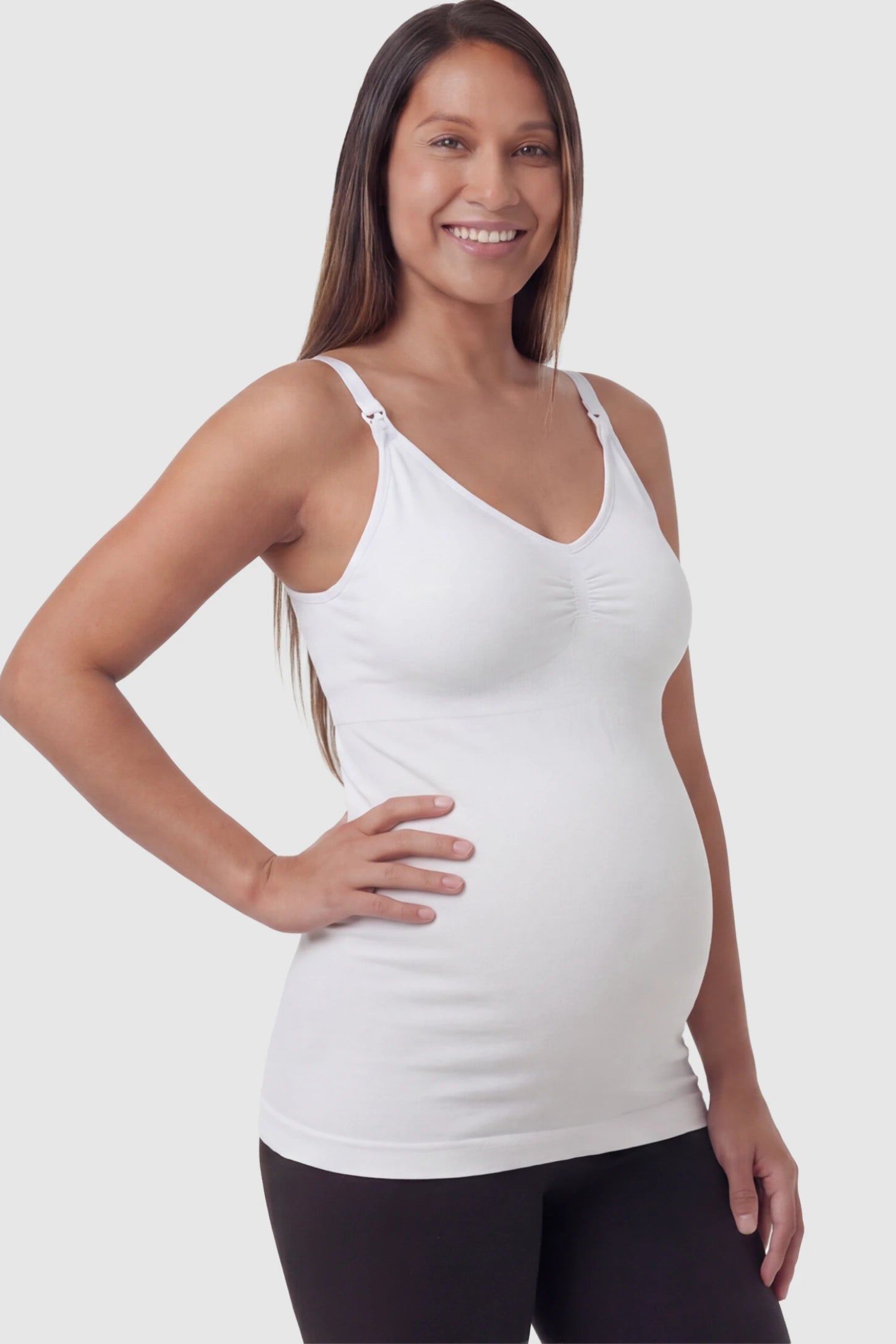 Solid Seamless Maternity & Nursing Camisole Solid Seamless Maternity & Nursing Camisole in White featuring one-handed nursing clips on a pregnant model.