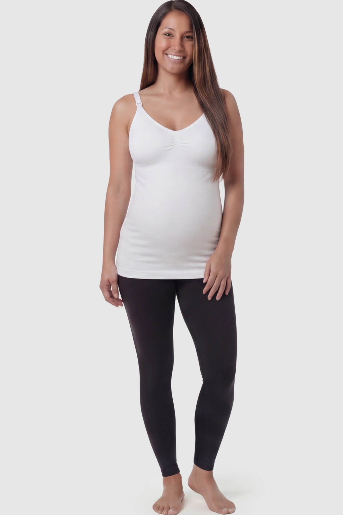 Solid Seamless Maternity & Nursing Camisole Solid Seamless Maternity & Nursing Camisole in White featuring one-handed nursing clips on a pregnant model.