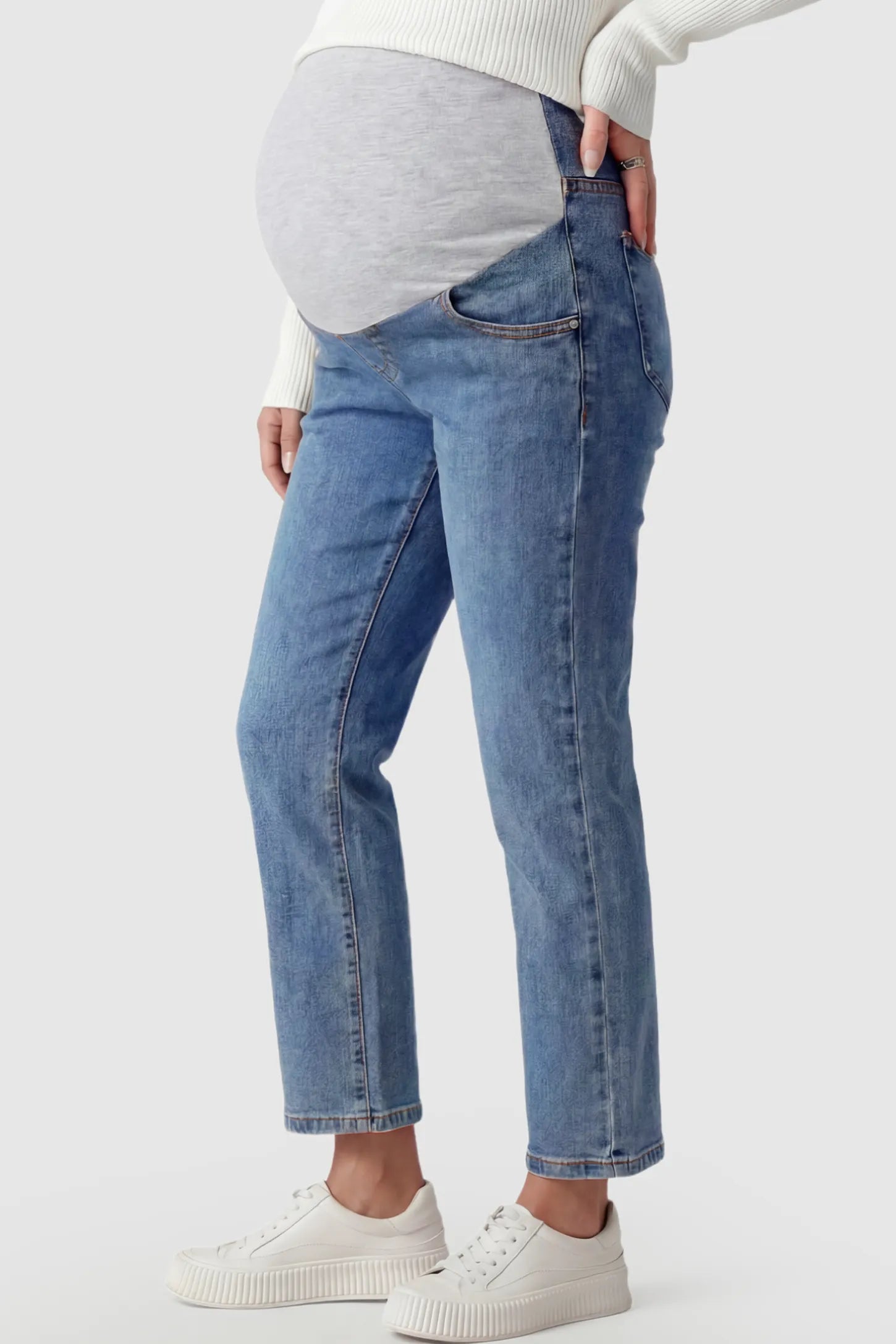 Elastic Full Panel Straight Leg Maternity Jeans Elastic Full Panel Straight Leg Maternity Jeans in Denim Blue featuring a high-stretch jersey waistband on a pregnant model.