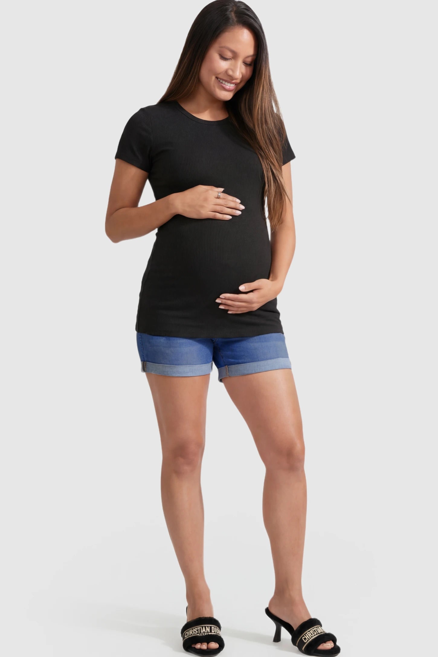 High Waist Rolled-Hem Maternity Denim Shorts in Dark Blue featuring a navy over-the-belly panel on a pregnant model.
