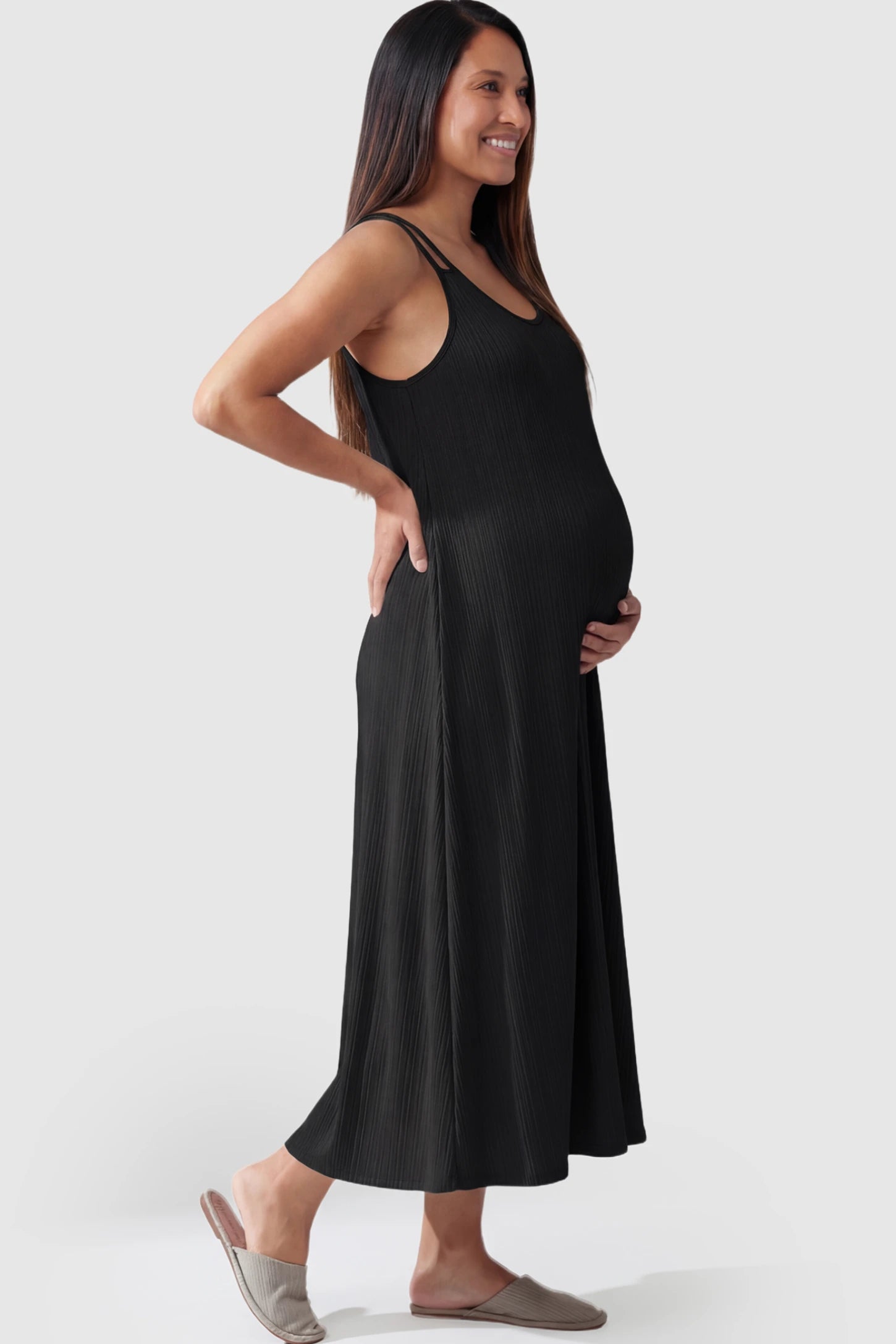 Double-Strap Sleeveless Maternity Slip Dress Double-Strap Sleeveless Maternity Slip Dress in black ribbed knit fabric on a pregnant model.