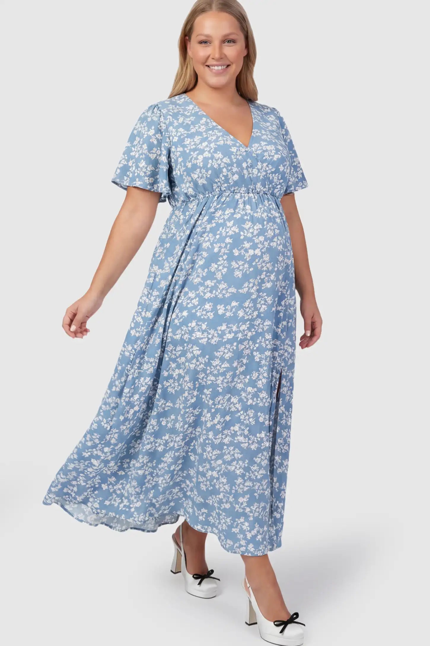 Floral V-Neck Side-Slit Maternity Maxi Dress Floral V-Neck Side-Slit Maternity Maxi Dress in blue on a pregnant model.