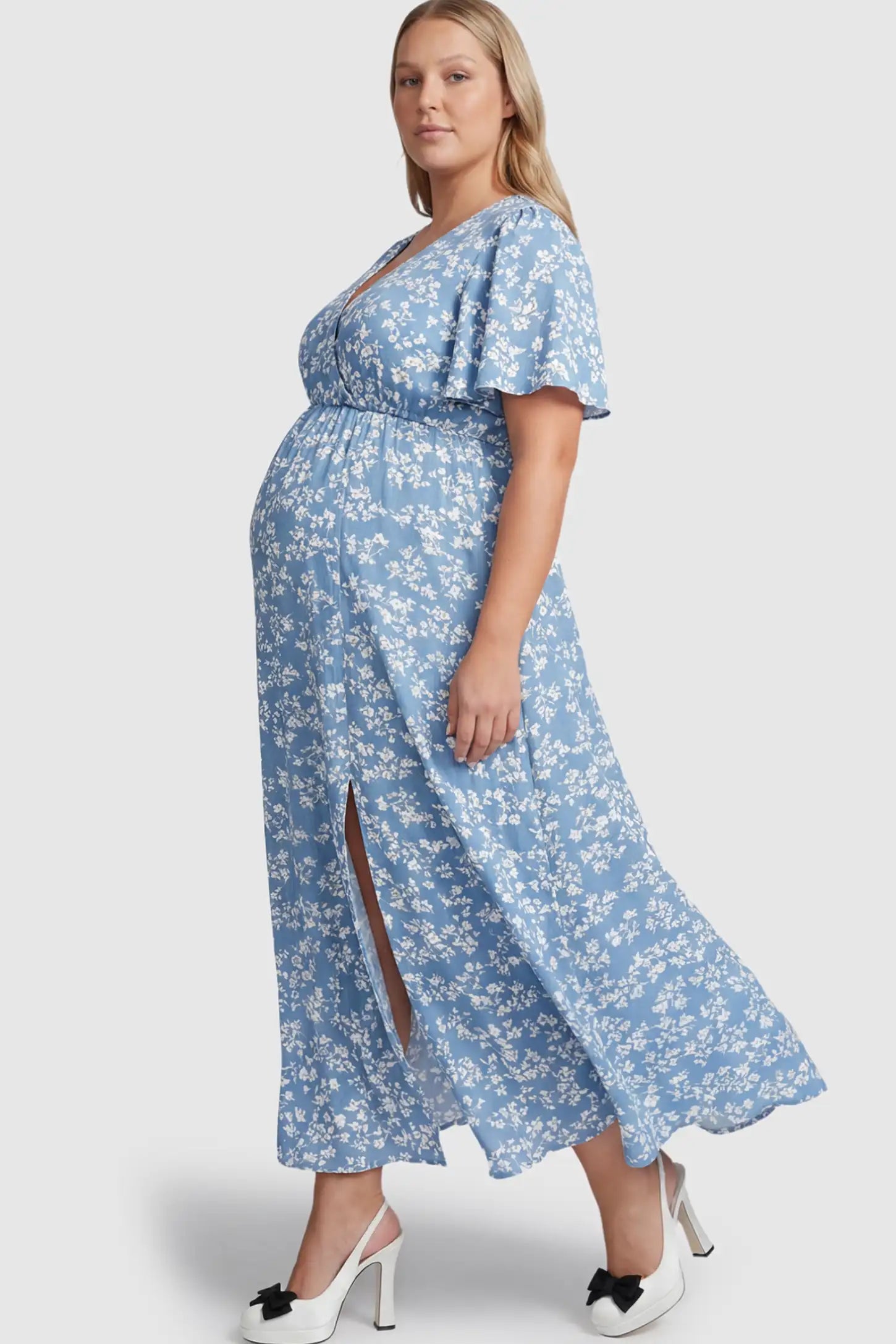 Floral V-Neck Side-Slit Maternity Maxi Dress Floral V-Neck Side-Slit Maternity Maxi Dress in blue on a pregnant model.