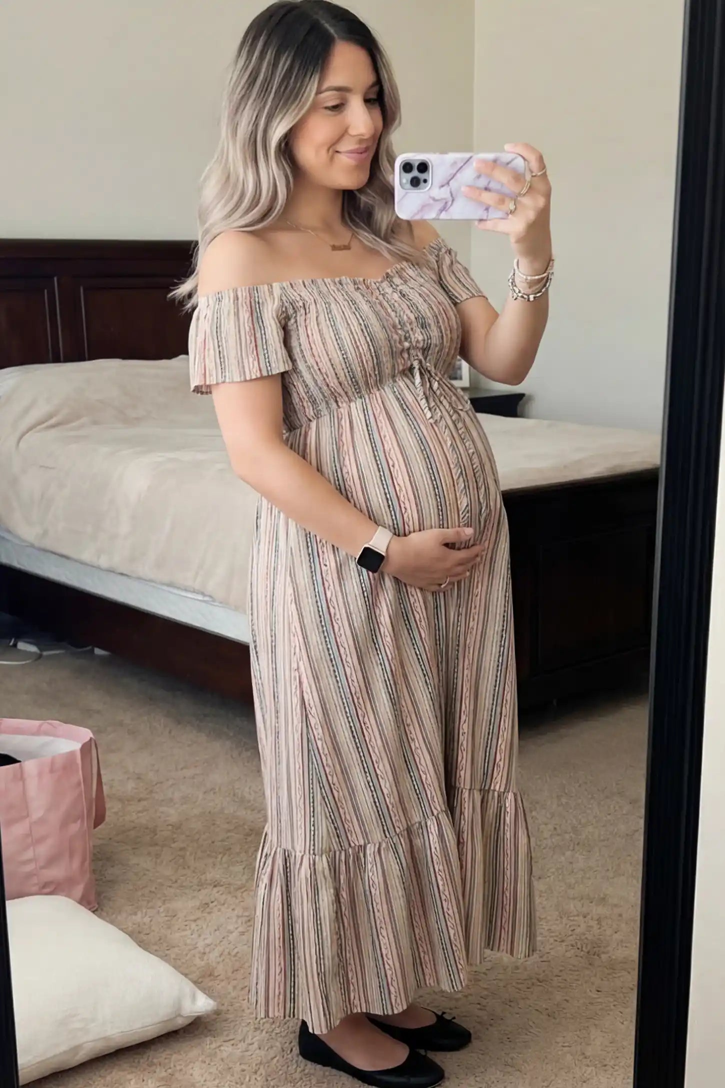 Striped Off Shoulder Ruffle Hem Maternity Maxi Dress Striped Off-the-Shoulder Ruffle Hem Maternity Maxi Dress in multi colors featuring a flounced hem on a pregnant model.