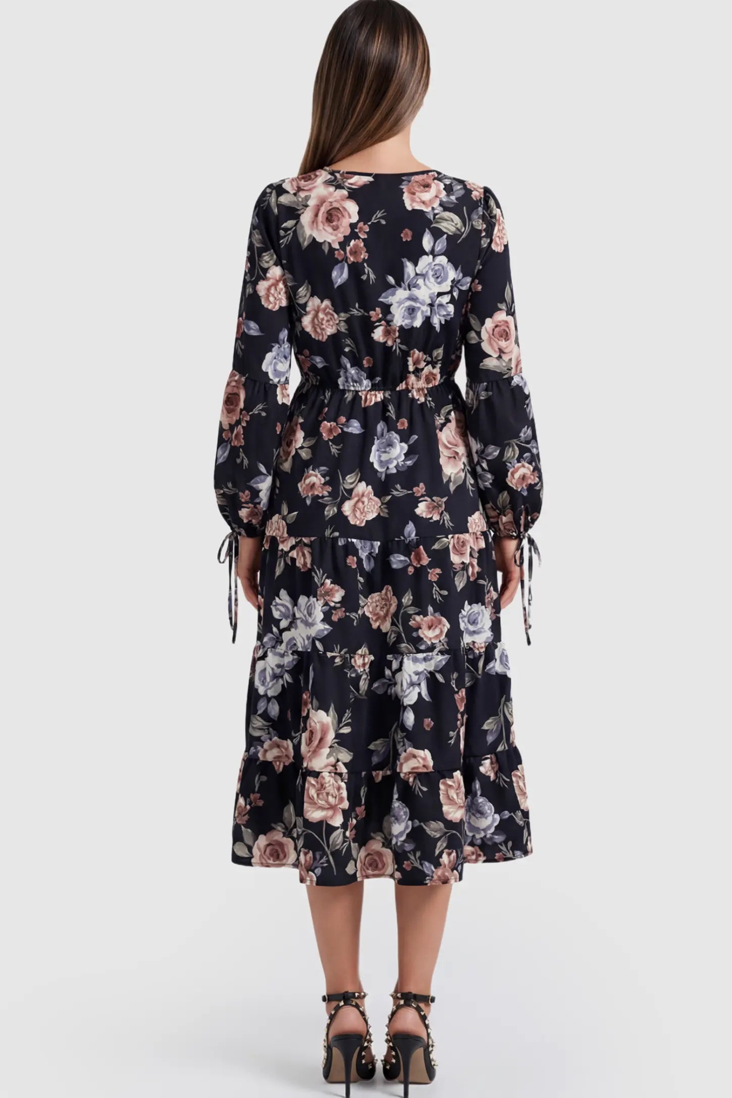 Floral Print Tiered Maternity Midi Dress Floral Print Tiered Midi Maternity Dress in dark floral featuring adjustable tie-cuff sleeves on a pregnant model.