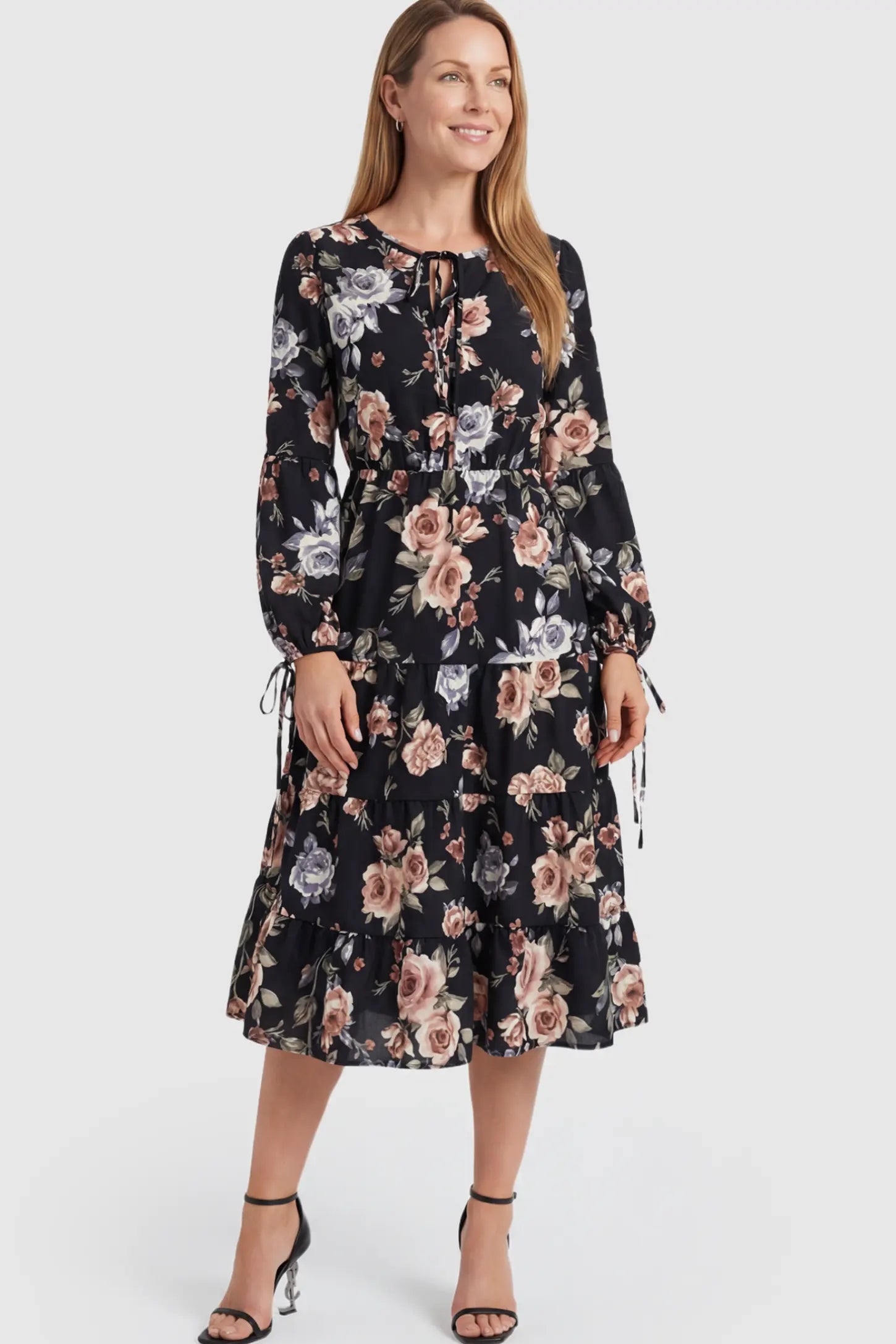Floral Print Tiered Maternity Midi Dress Floral Print Tiered Midi Maternity Dress in dark floral featuring adjustable tie-cuff sleeves on a postpartum model.