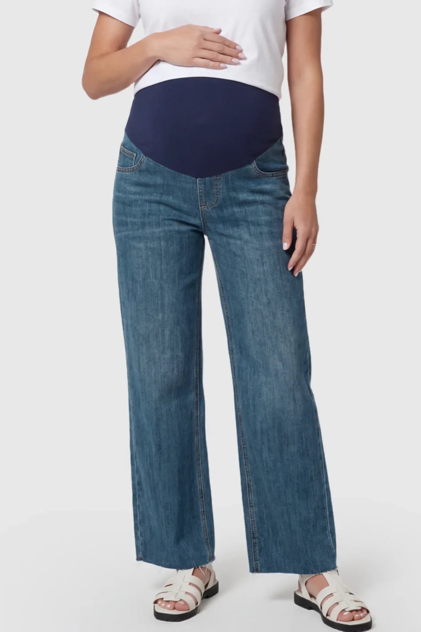 Full Panel Wide Leg Maternity Jeans in Dark Blue featuring a seamless tummy-support band on a pregnant model showing front.