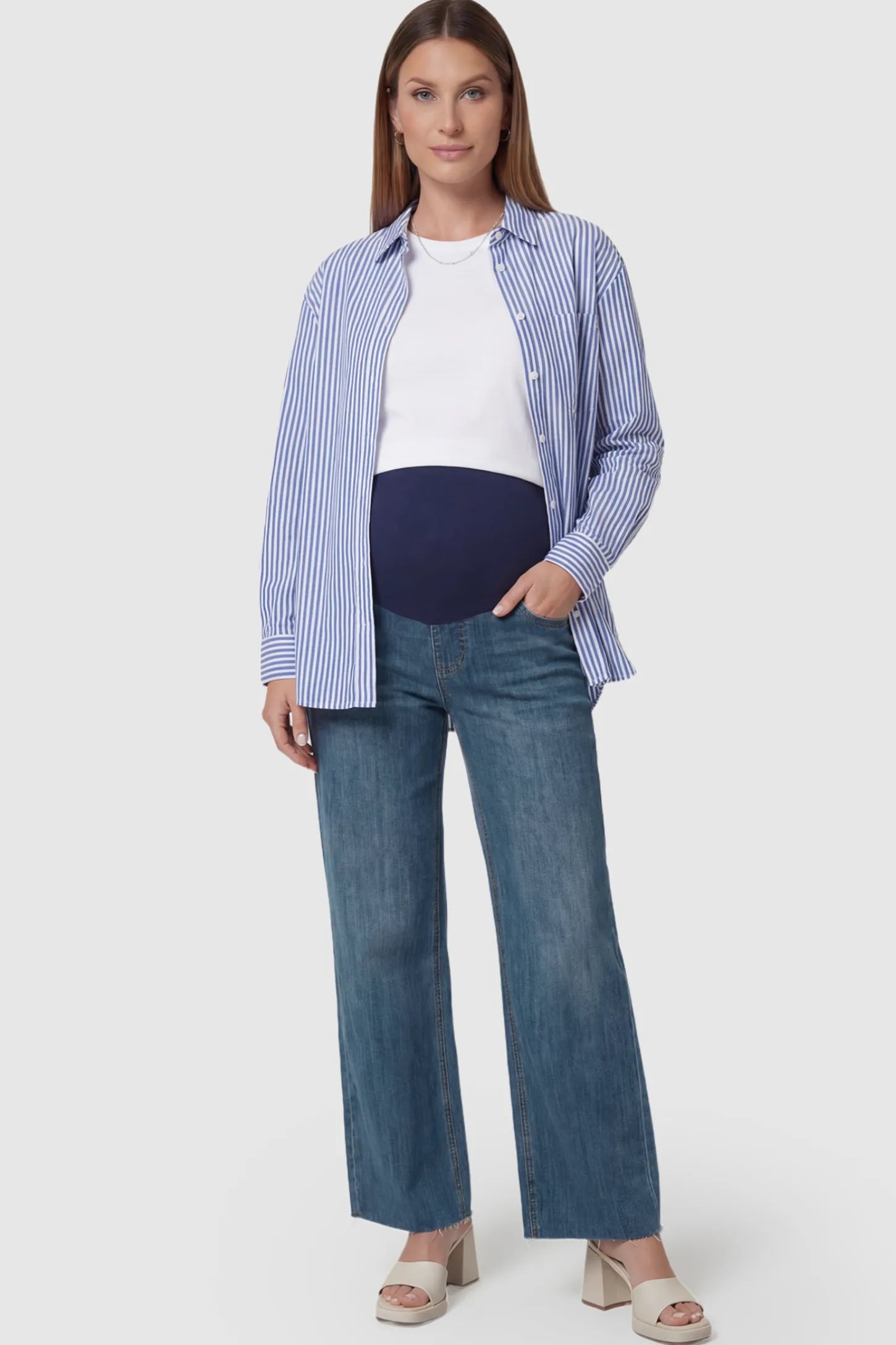 Full Panel Wide Leg Maternity Jeans Full Panel Wide Leg Maternity Jeans in Dark Blue featuring a seamless tummy-support band on a pregnant model facing front.