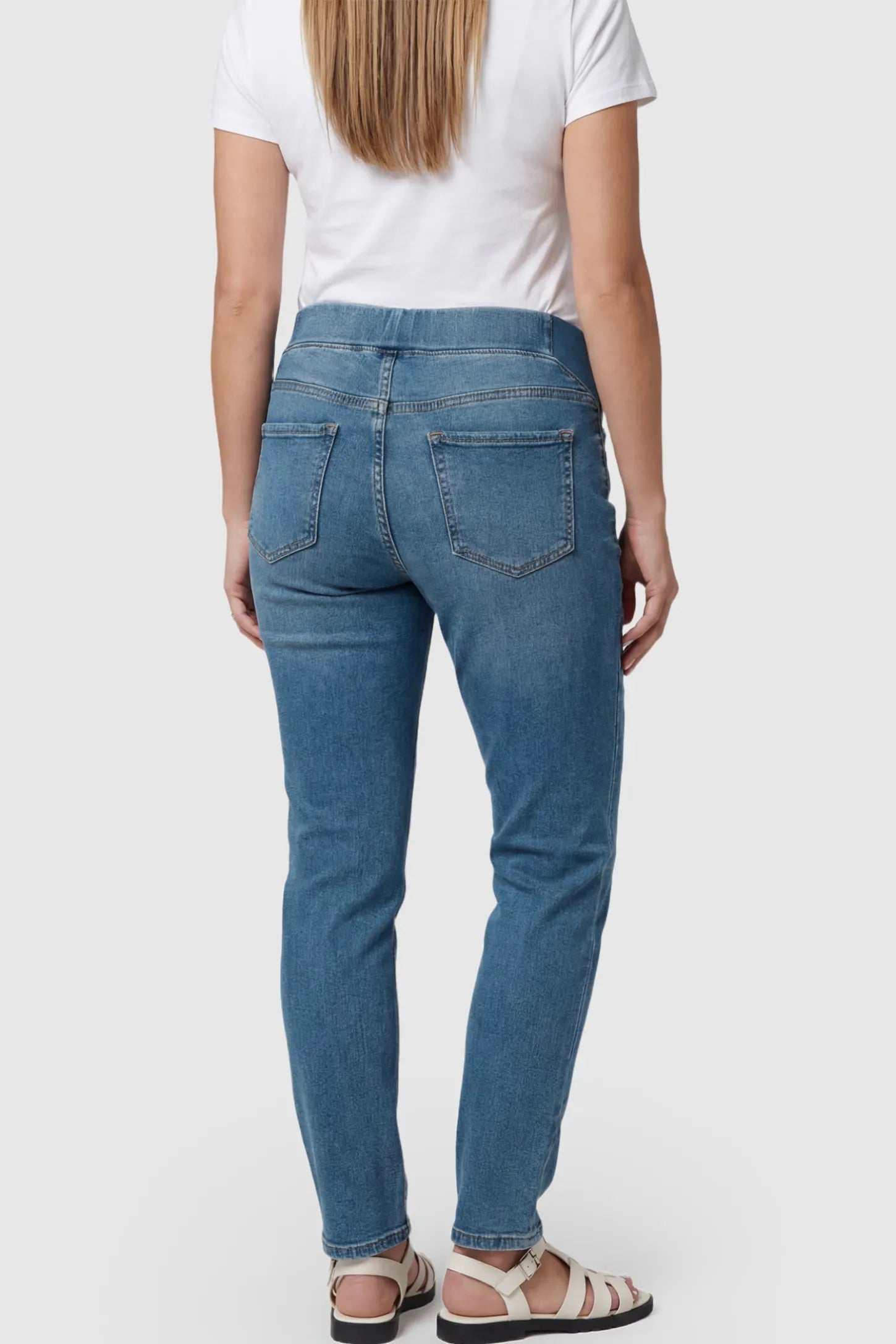 Full Panel Wide Leg Maternity Jeans Full Panel Wide Leg Maternity Jeans in Dark Blue featuring a seamless tummy-support band on a pregnant model showing back.