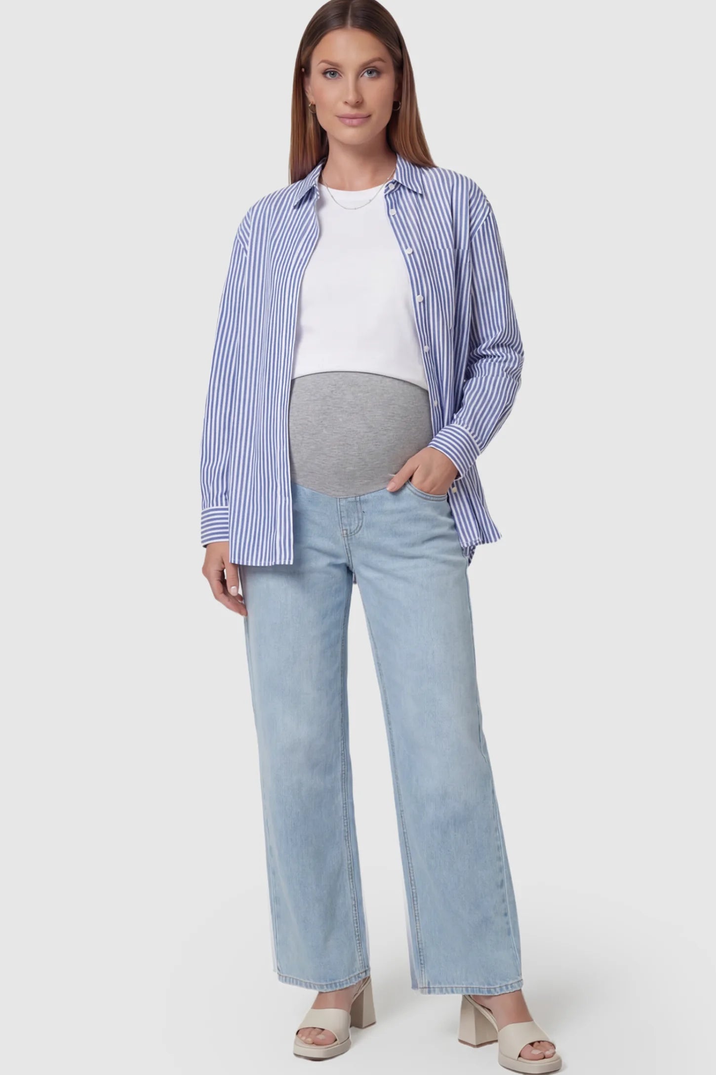 Full Panel Wide Leg Maternity Jeans Full Panel Wide Leg Maternity Jeans in light Blue featuring a seamless tummy-support band on a pregnant model facing front.