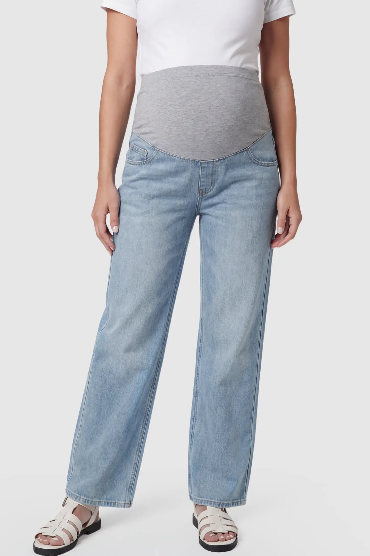Full Panel Wide Leg Maternity Jeans Full Panel Wide Leg Maternity Jeans in light Blue featuring a seamless tummy-support band on a pregnant model showing front.
