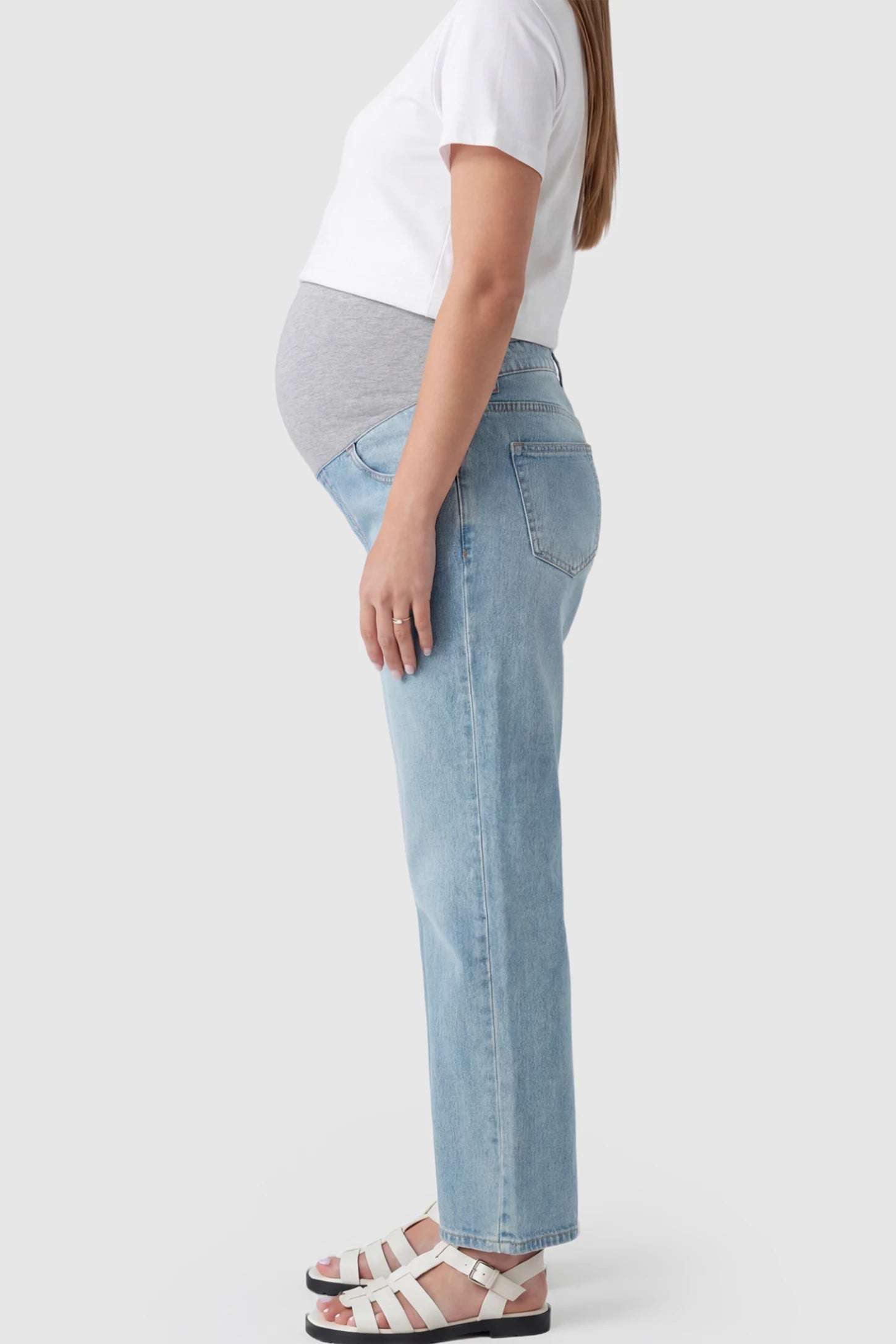 Full Panel Wide Leg Maternity Jeans Full Panel Wide Leg Maternity Jeans in light Blue featuring a seamless tummy-support band on a pregnant model showing side.
