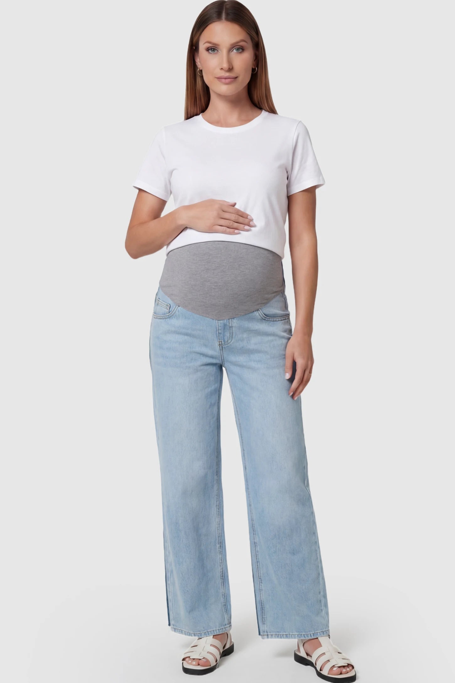 Full Panel Wide Leg Maternity Jeans Full Panel Wide Leg Maternity Jeans in light Blue featuring a seamless tummy-support band on a pregnant model facing front.