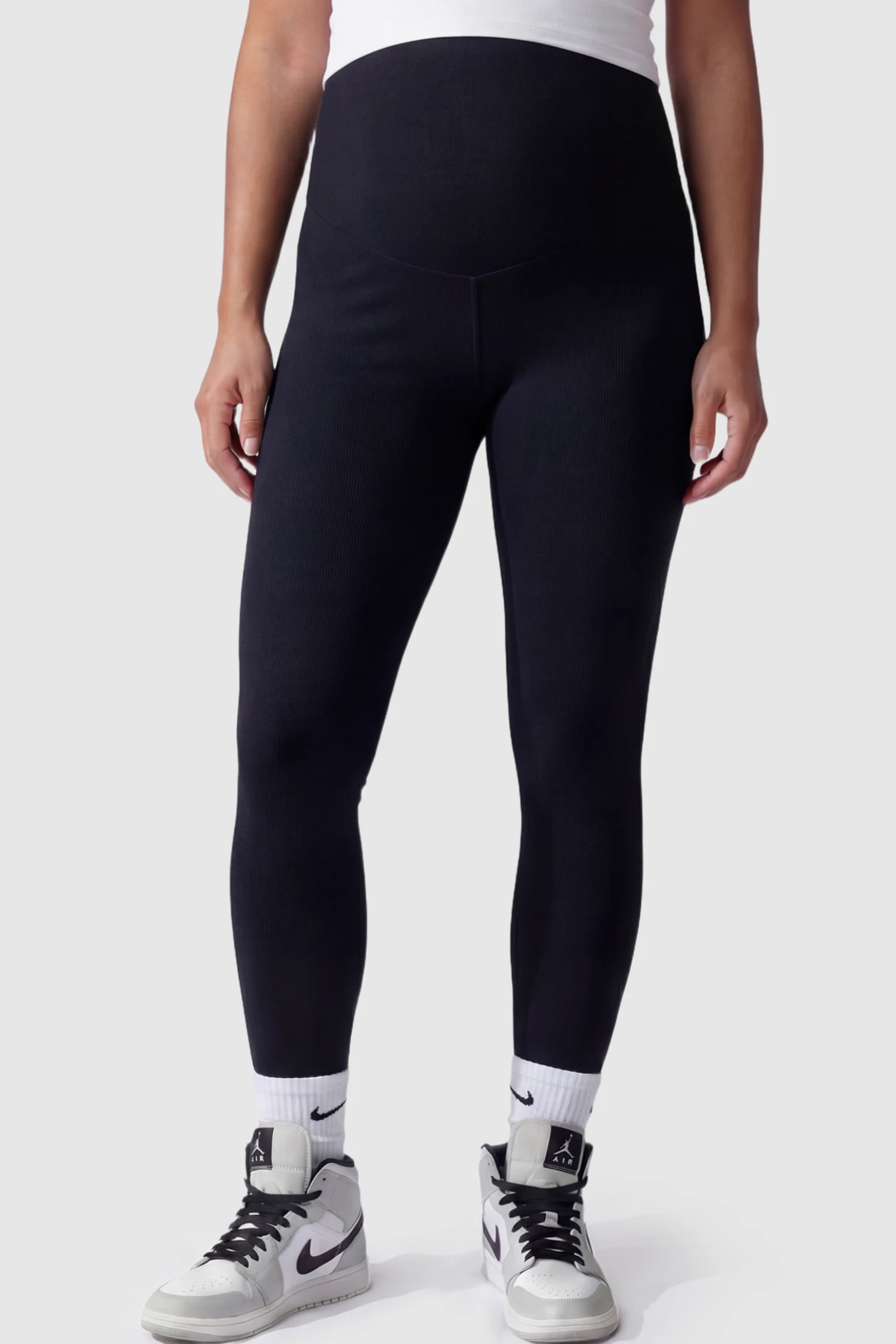 High Waist Slim Fit Maternity Leggings in Black featuring a seamless full-panel on a pregnant model.