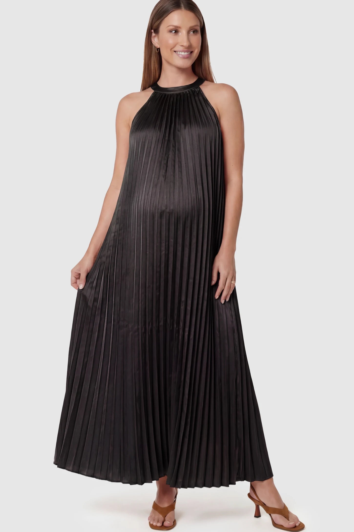 Pleated Faux Silk Halter Maternity Maxi Dress Pleated Faux Silk Halter Maternity Maxi Dress in Black featuring micro-pleat texture on a pregnant model facing front.