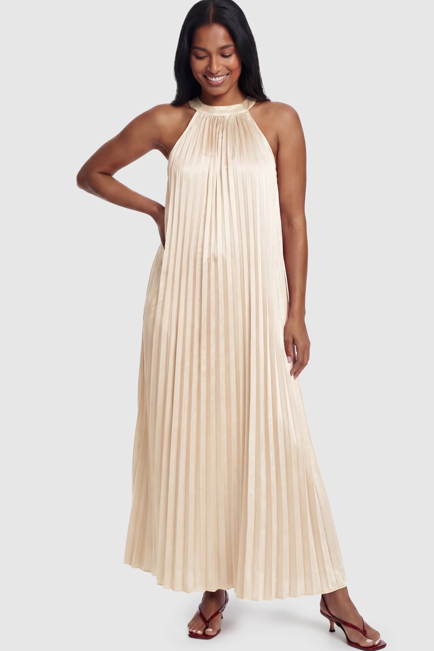 Pleated Faux Silk Halter Maternity Maxi Dress Pleated Faux Silk Halter Maternity Maxi Dress in Champagne featuring micro-pleat texture on a postpartum model facing front.