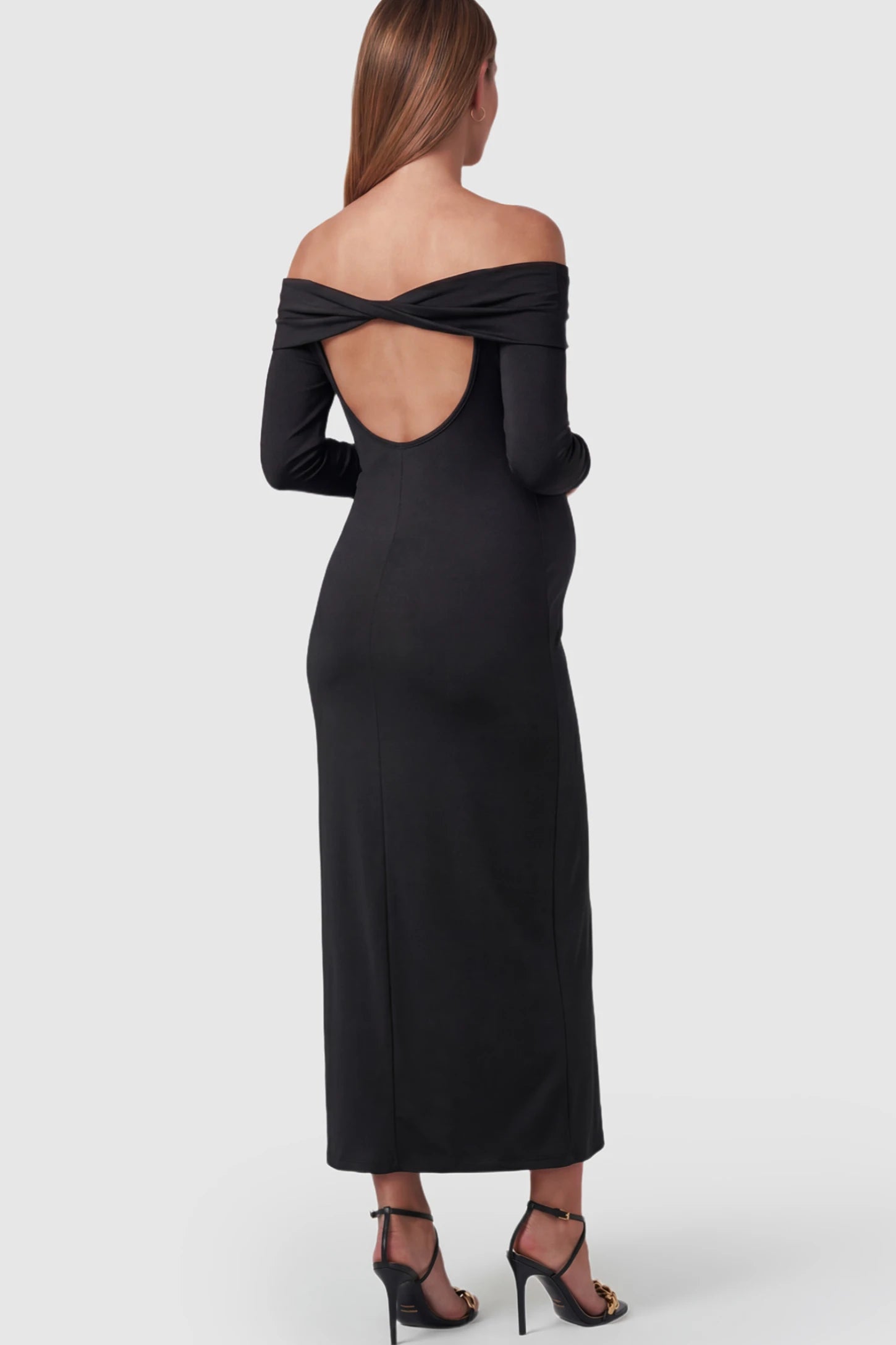 Solid Off Shoulder Bodycon Maternity Maxi Dress Off Shoulder Bodycon Maternity Maxi Dress in Black featuring a back cutout on a pregnant model.