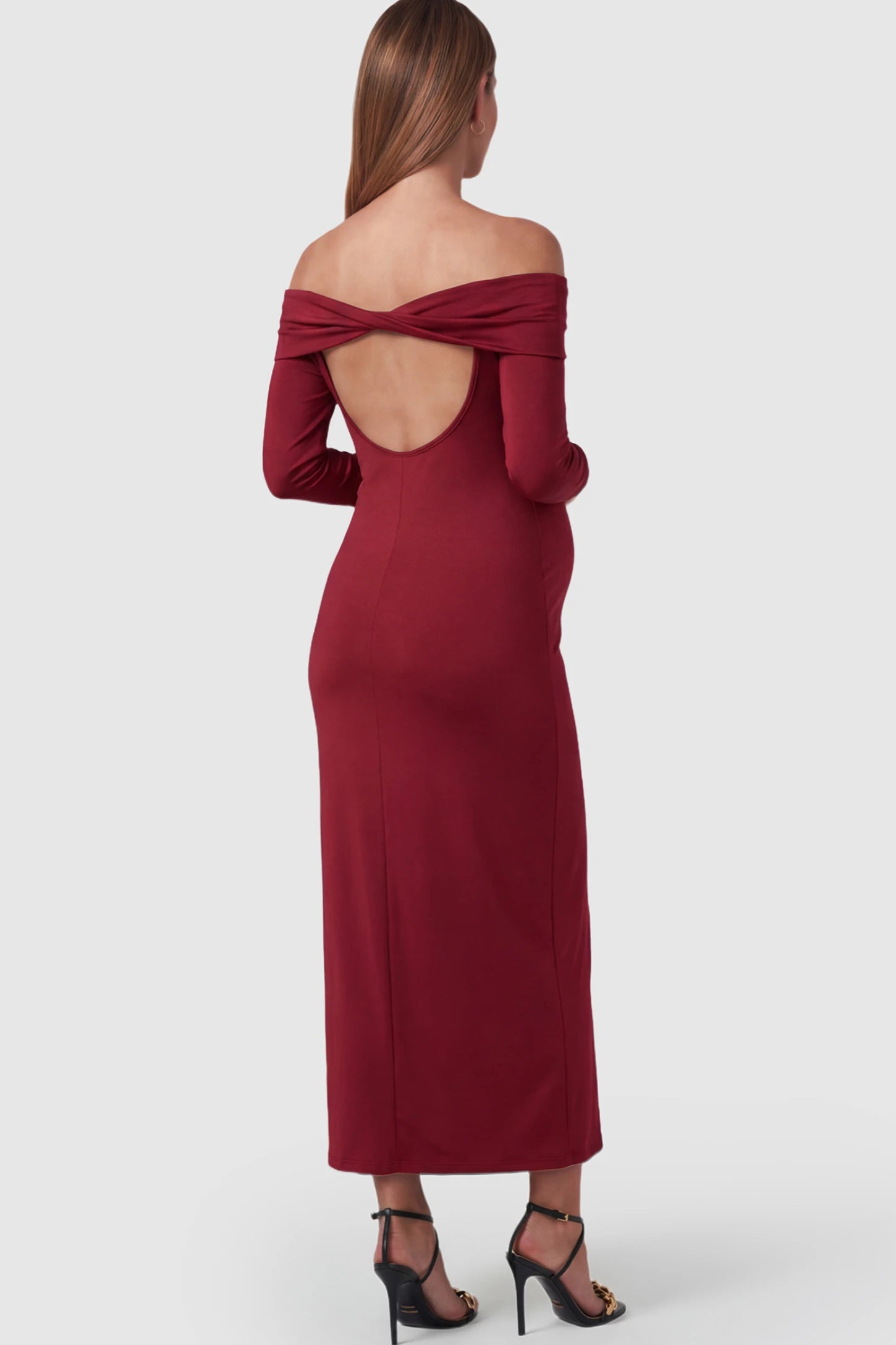 Solid Off Shoulder Bodycon Maternity Maxi Dress Off Shoulder Bodycon Maternity Maxi Dress in Red featuring a back cutout on a pregnant model.