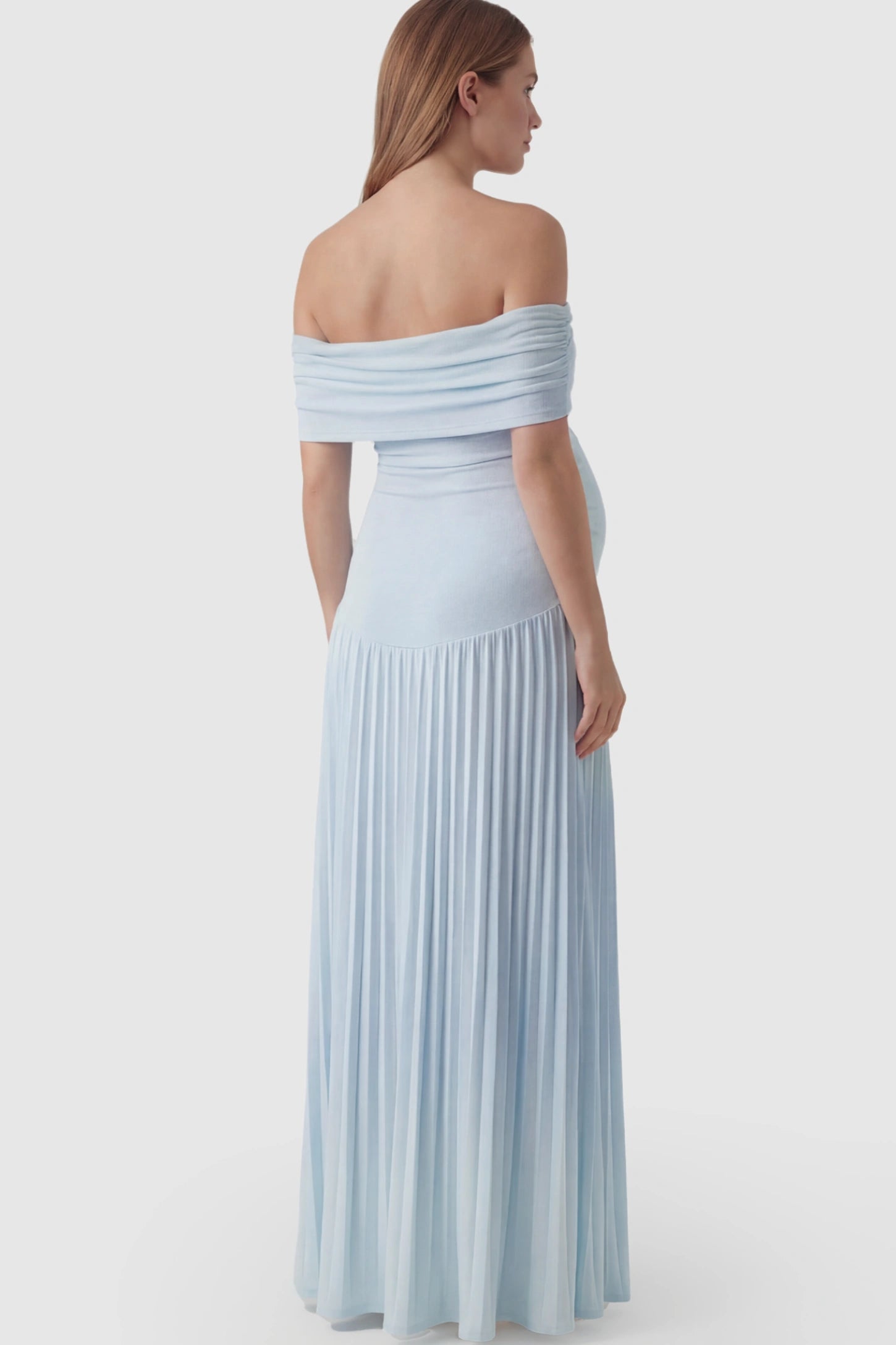 Pleated Off Shoulder Maternity Maxi Dress Pleated Off Shoulder Maternity Maxi Dress in Light Blue featuring a floor-length silhouette on a pregnant model.