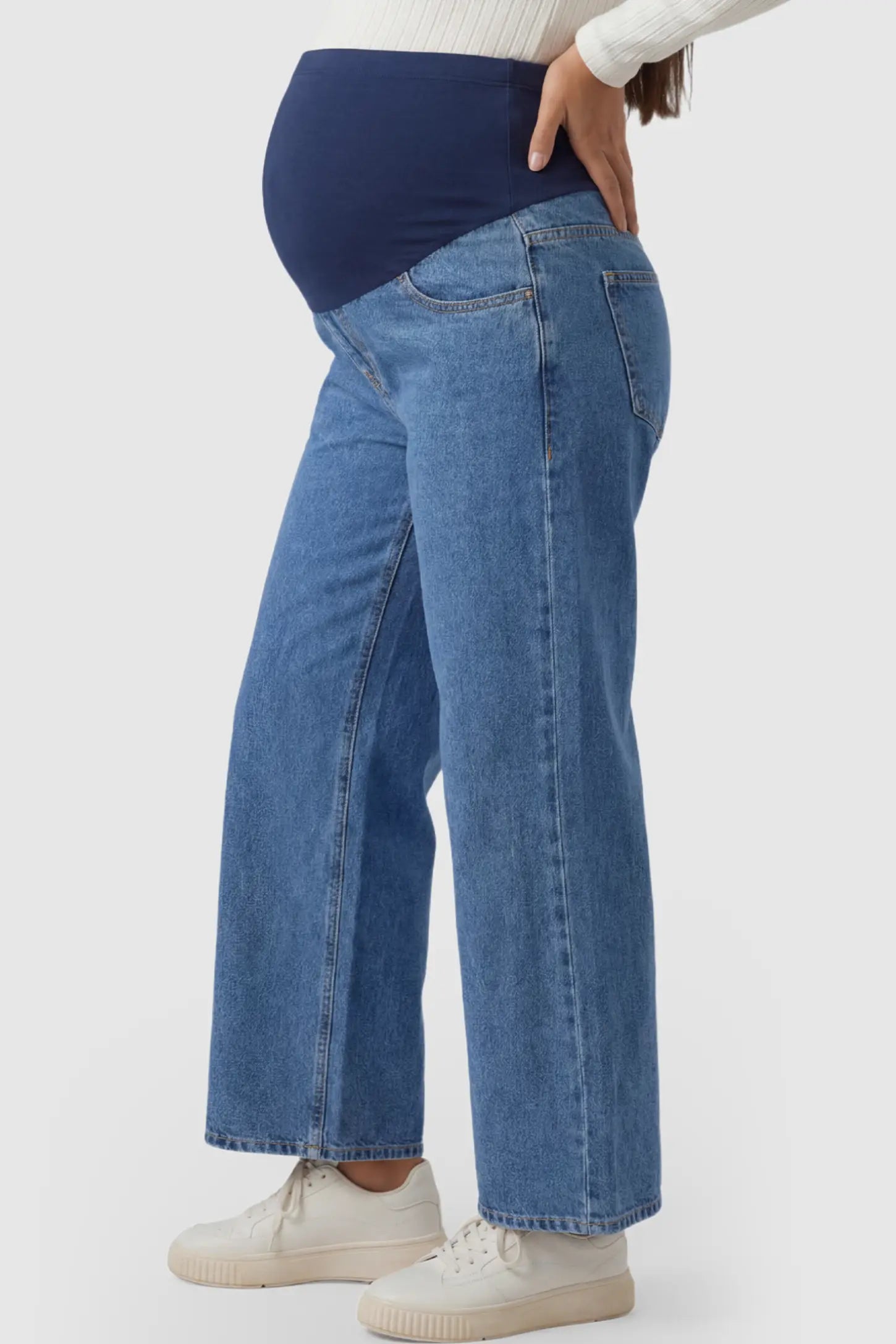Raw Hem Full Panel Wide Leg Maternity Jeans Raw Hem Full Panel Wide Leg Maternity Jeans in dark blue featuring a high-rise navy belly band on a pregnant model.