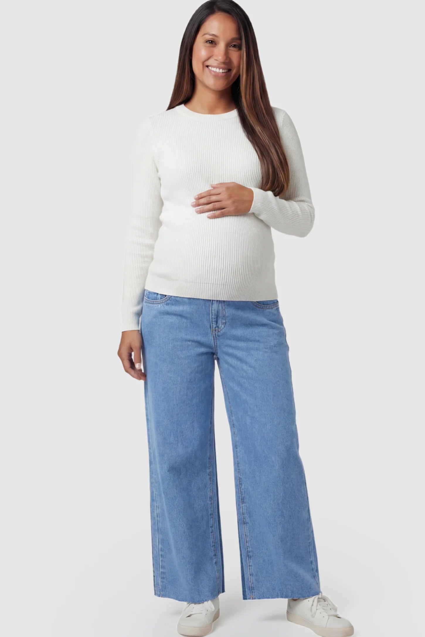 Raw Hem Full Panel Wide Leg Maternity Jeans Raw Hem Full Panel Wide Leg Maternity Jeans in light blue featuring a high-rise belly band on a pregnant model.