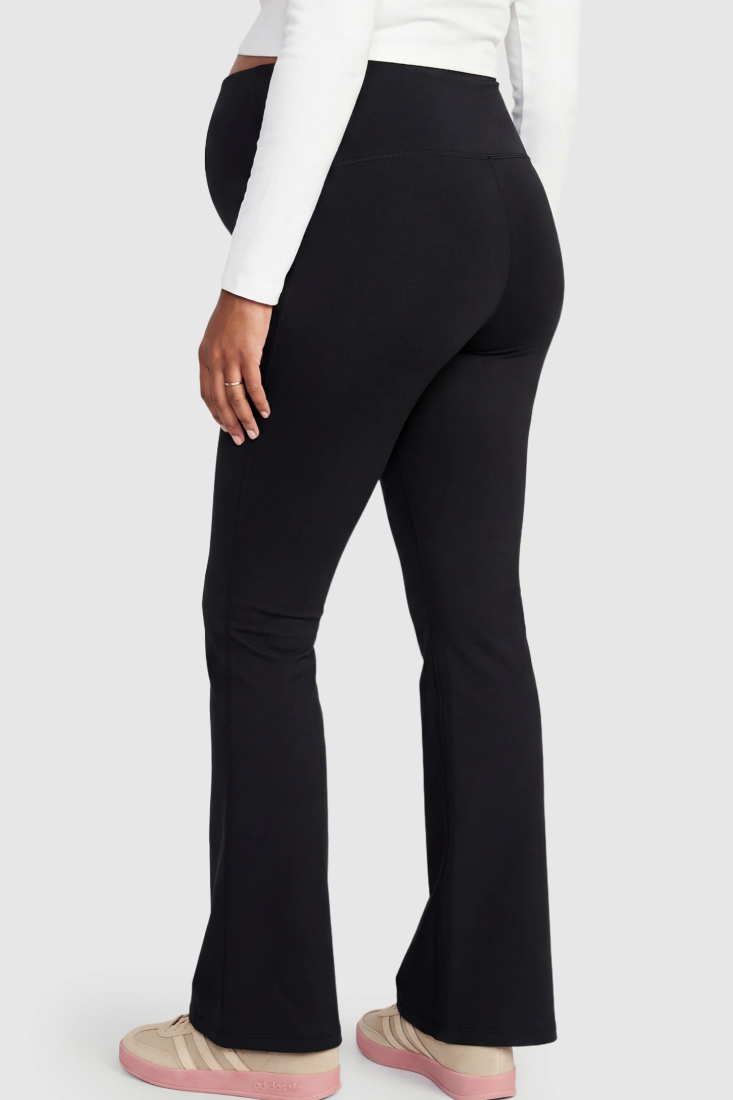 Crossover Waistline Flared Maternity Pants Crossover Waistline Flared Maternity Pants in Black featuring a V-shaped band on a pregnant model.