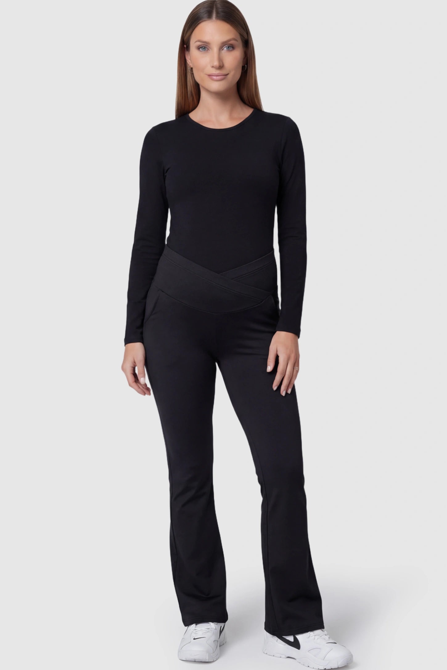 Crossover Waistline Flared Maternity Pants Crossover Waistline Flared Maternity Pants in Black featuring a V-shaped band on a postpartum model.