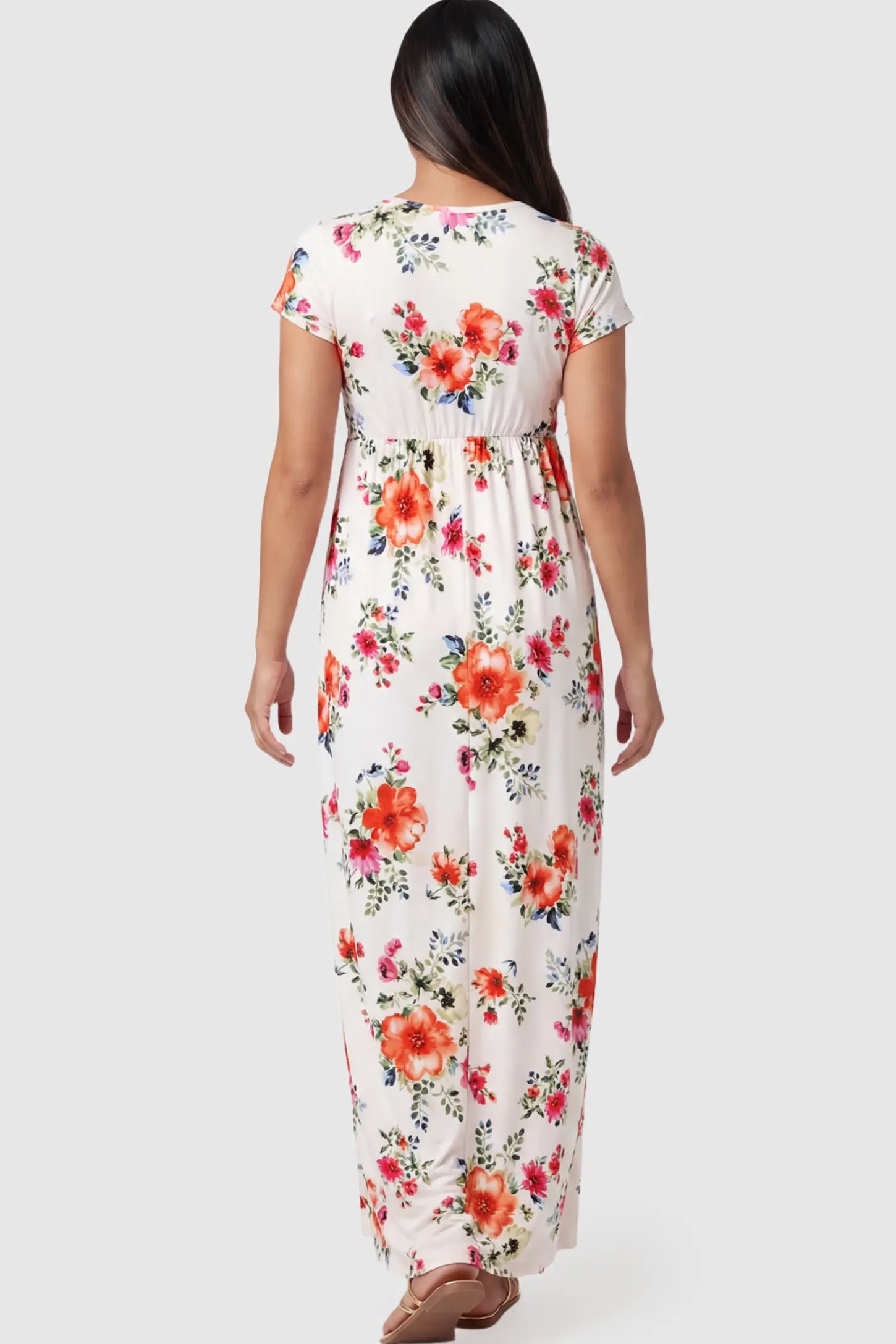 Floral Print V-Neck Maternity Maxi Dress Floral Print V-Neck Maternity Maxi Dress in White featuring a vibrant floral pattern on a pregnant model.
