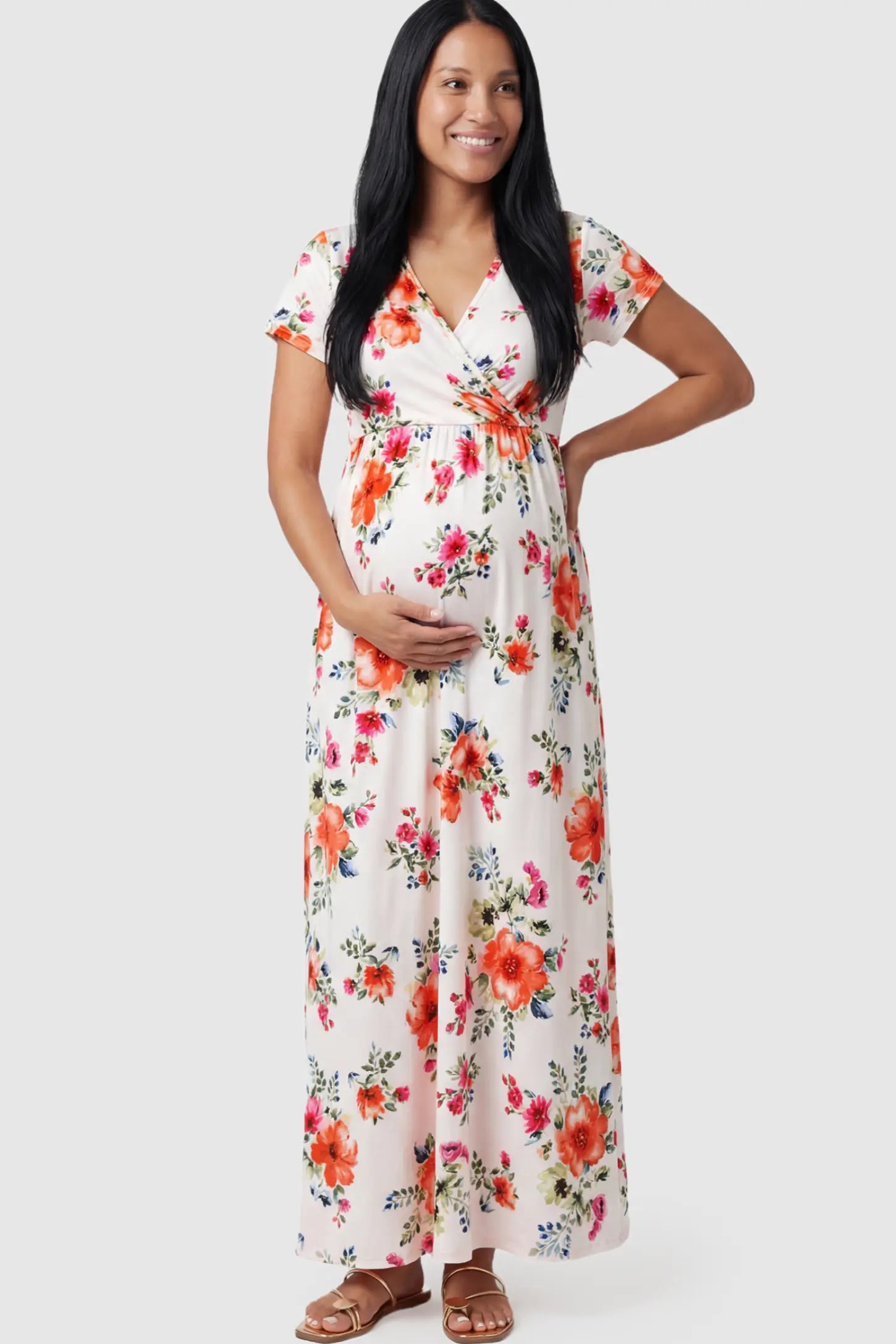 Floral Print V-Neck Maternity Maxi Dress Floral Print V-Neck Maternity Maxi Dress in White featuring a vibrant floral pattern on a pregnant model.